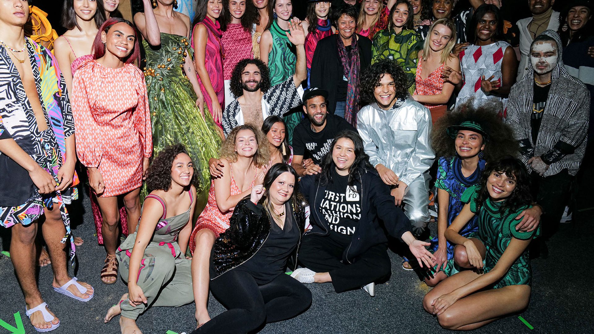 A large group of Indigenous models backstage at fashion week