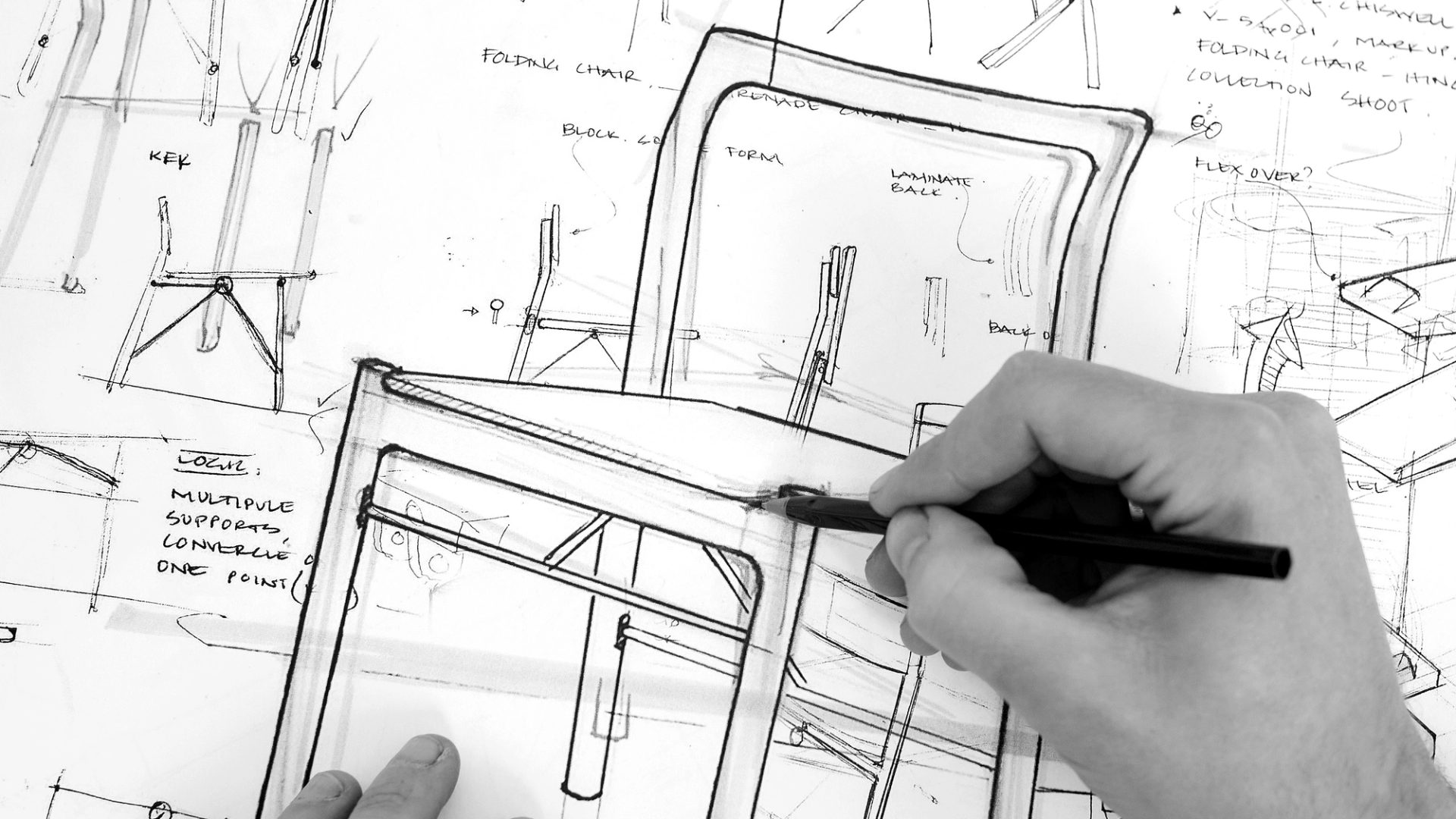 Black and white image of handing sketching a chair
