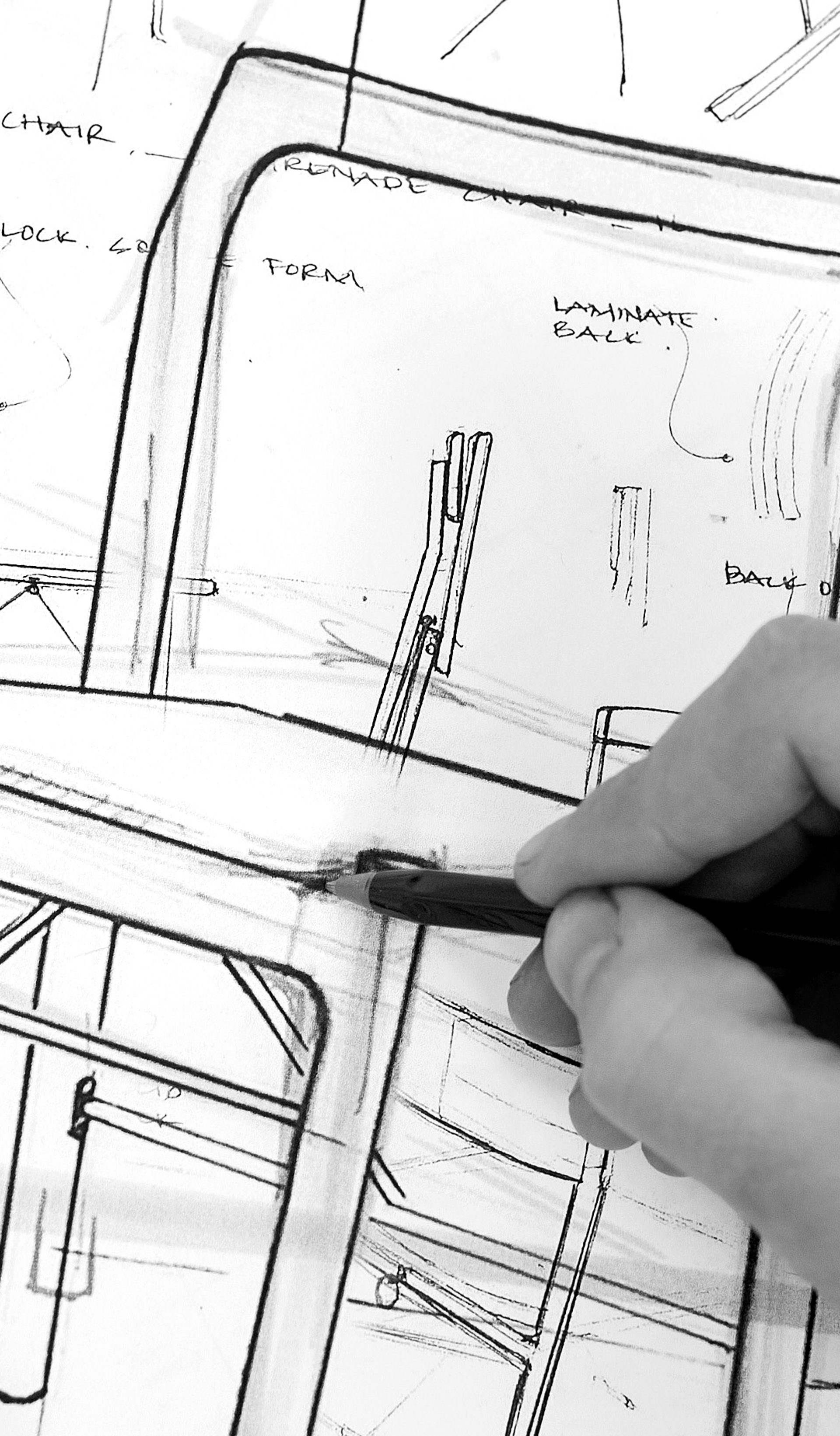 Black and white image of handing sketching a chair