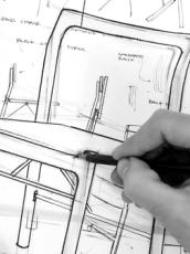 Black and white image of handing sketching a chair