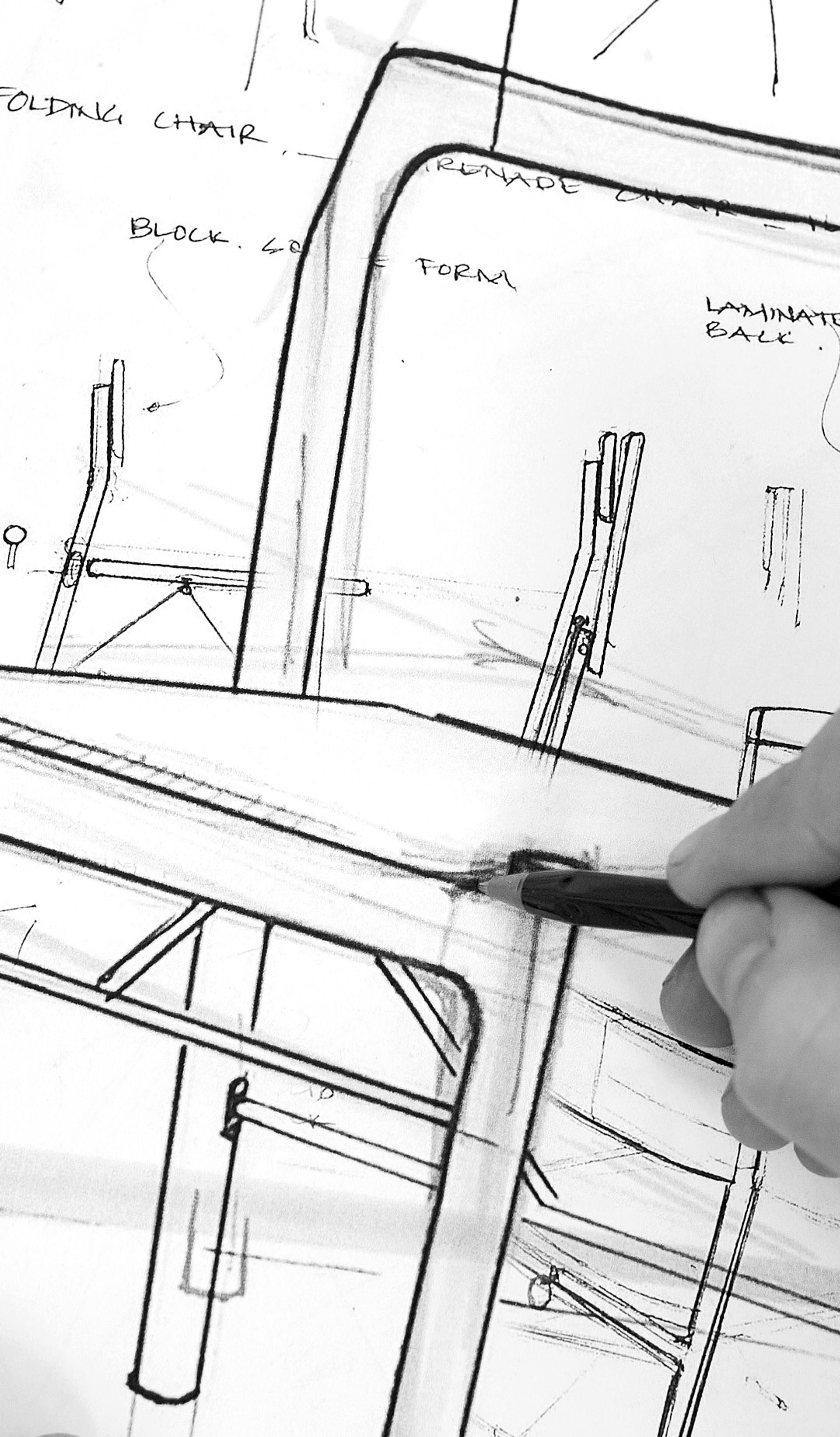 Black and white image of handing sketching a chair