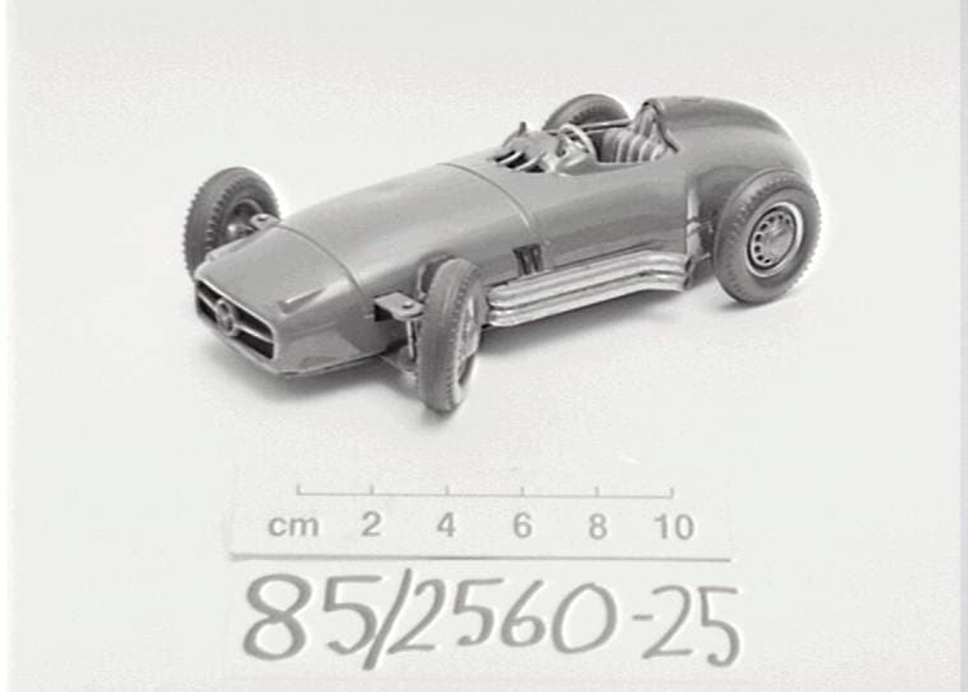 Black and white photo of a toy Mercedes single seat racing car