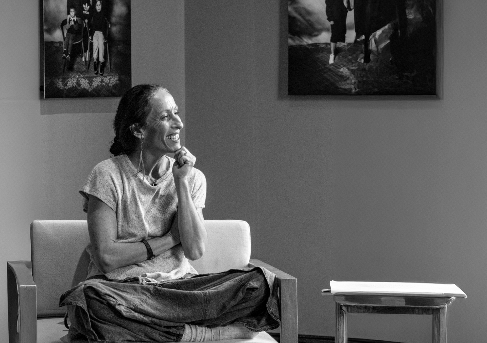 A Muruwarri Wiradjuri woman sits and listens to a conversation.