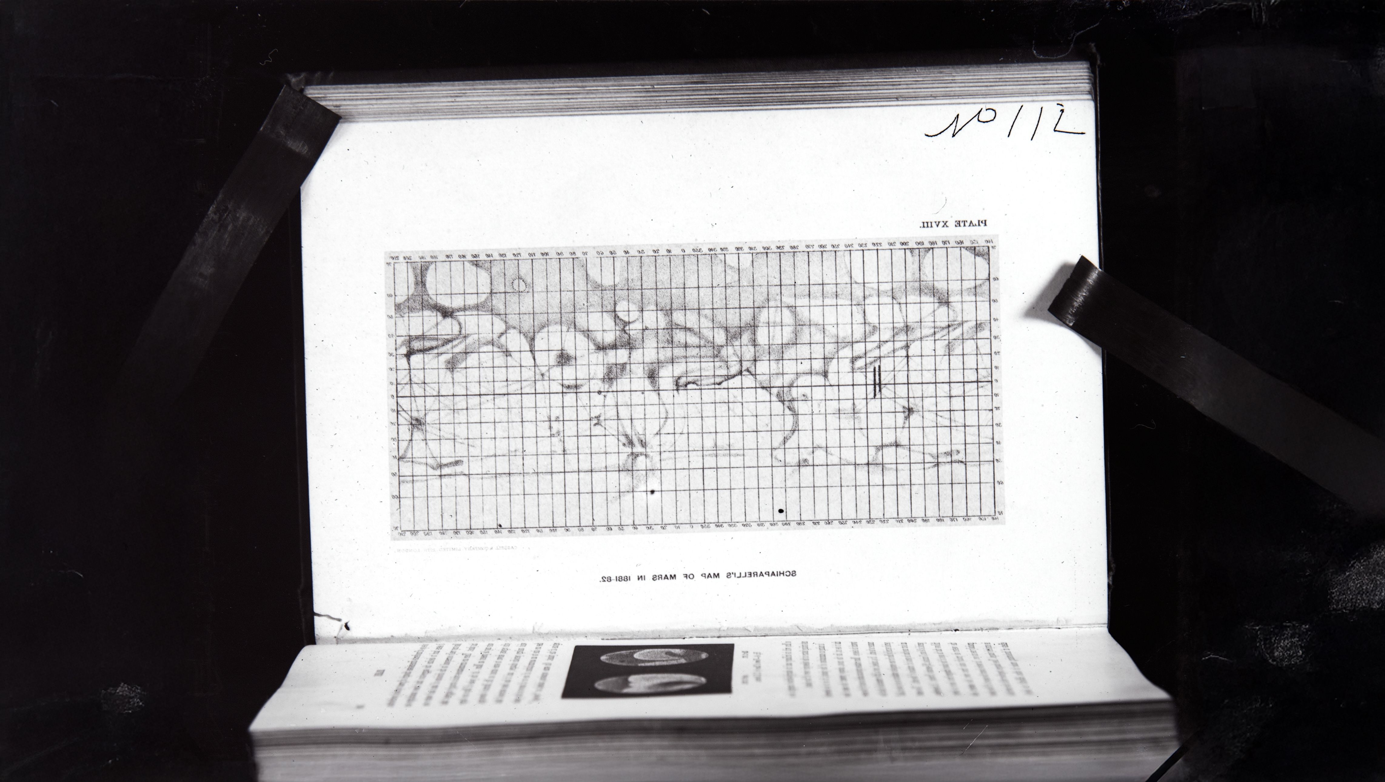 Scanned visual of a graph map of Mars within an open book.