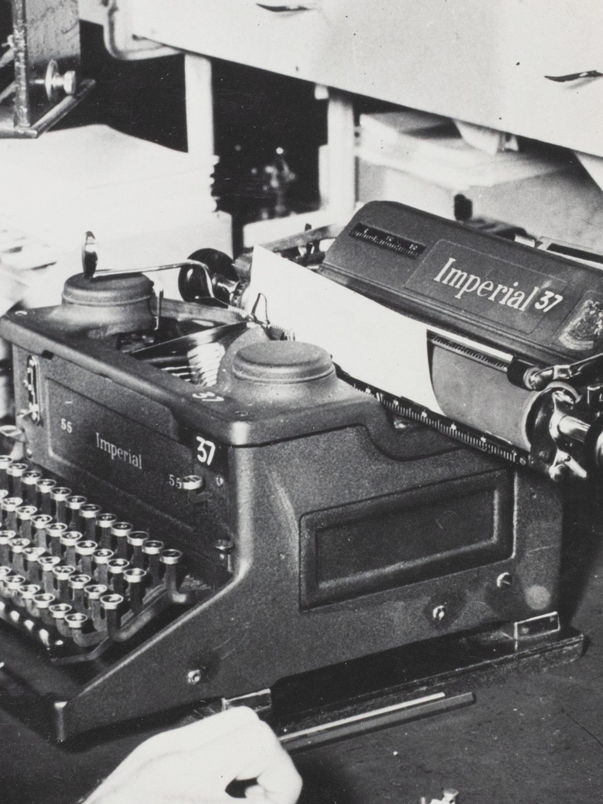 Black and white photograph of a morse code operator, a gentleman at a desk with morse code equipment.