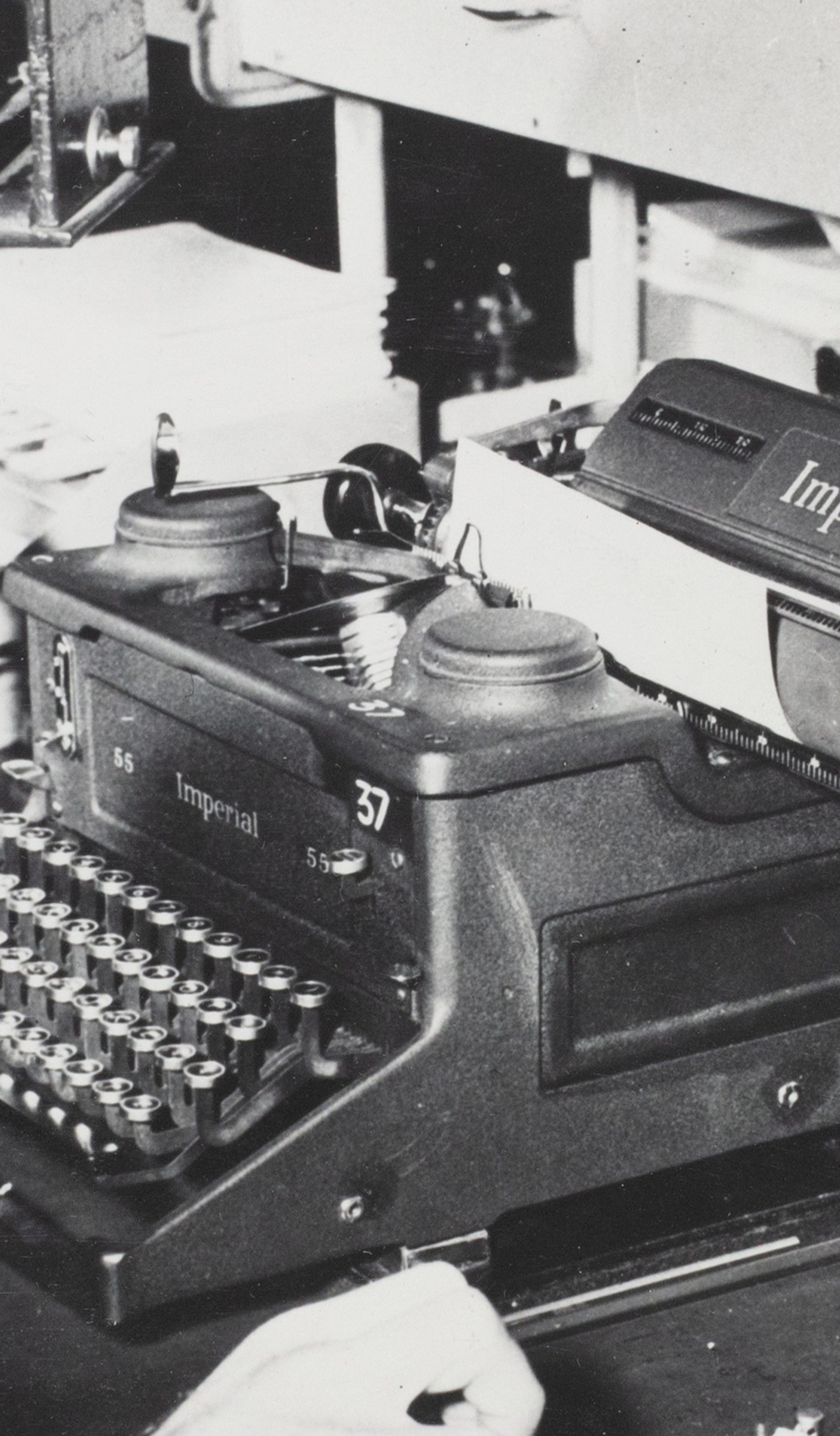 Black and white photograph of a morse code operator, a gentleman at a desk with morse code equipment.