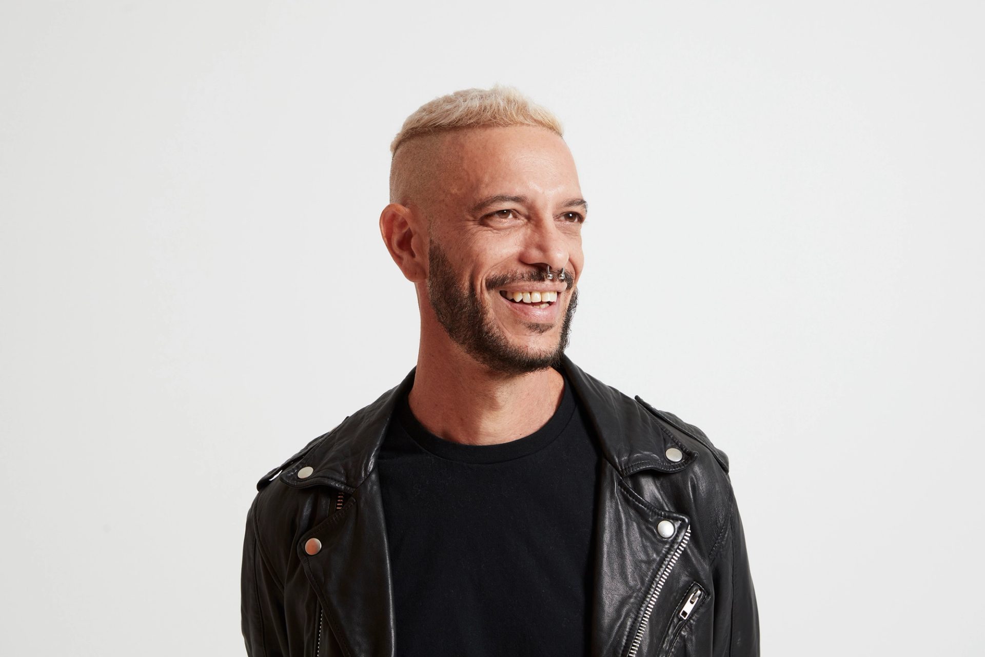 A headshot of a figure wearing a black leather jacket