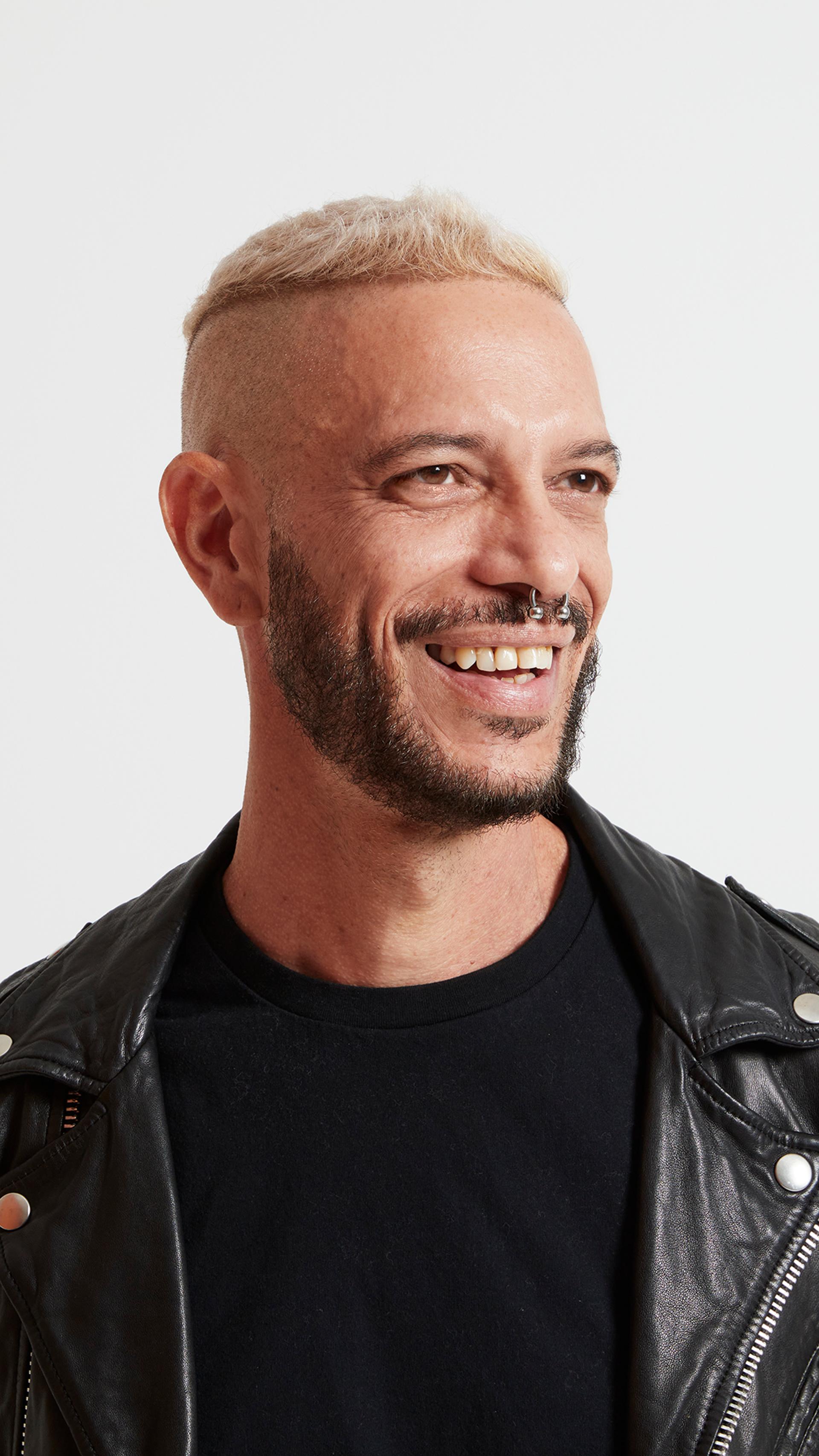 A headshot of a figure wearing a black leather jacket