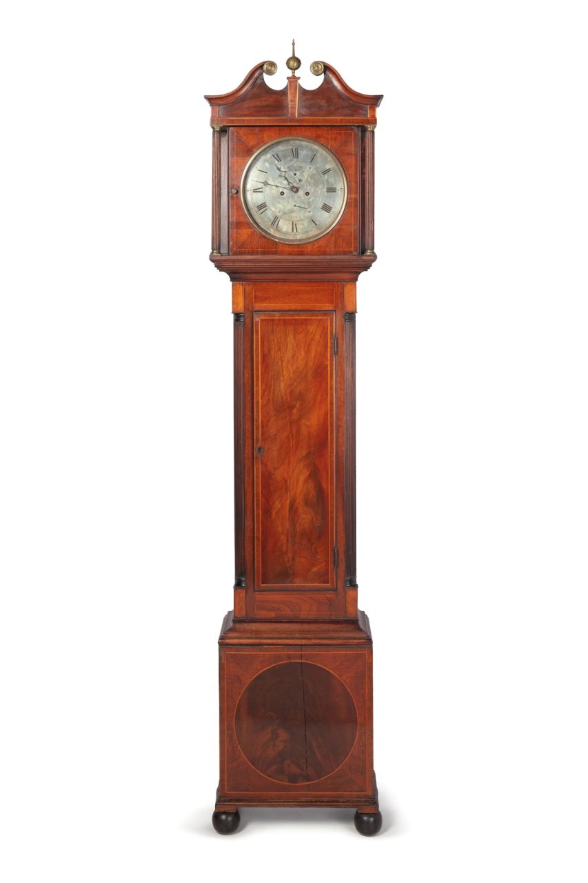Long case clock made out of wood.