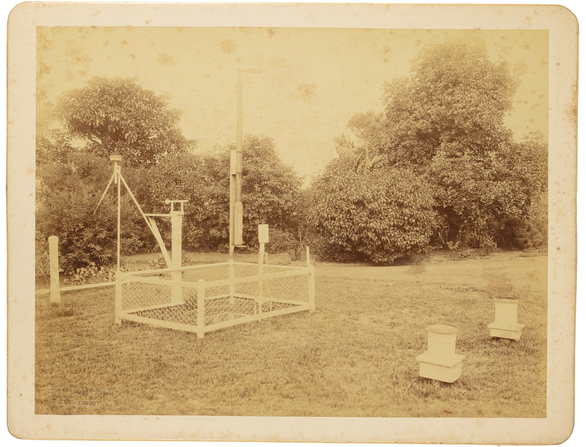 Sepia photographic card showing a vintage telescope