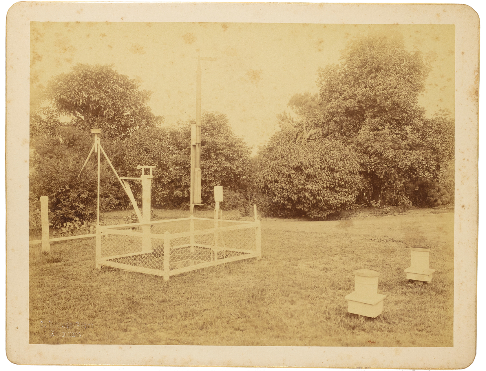 Sepia photographic card showing a vintage telescope