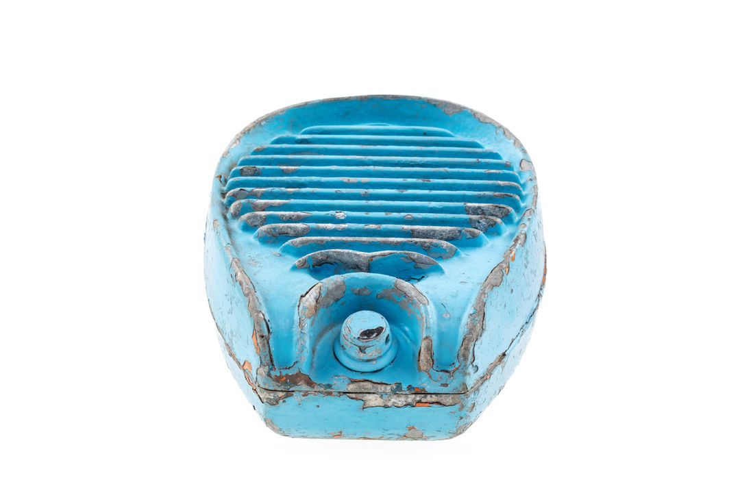 Metal casing painted blue, the casing has rounded edges and a circular grill at the front to allow sound to escape.