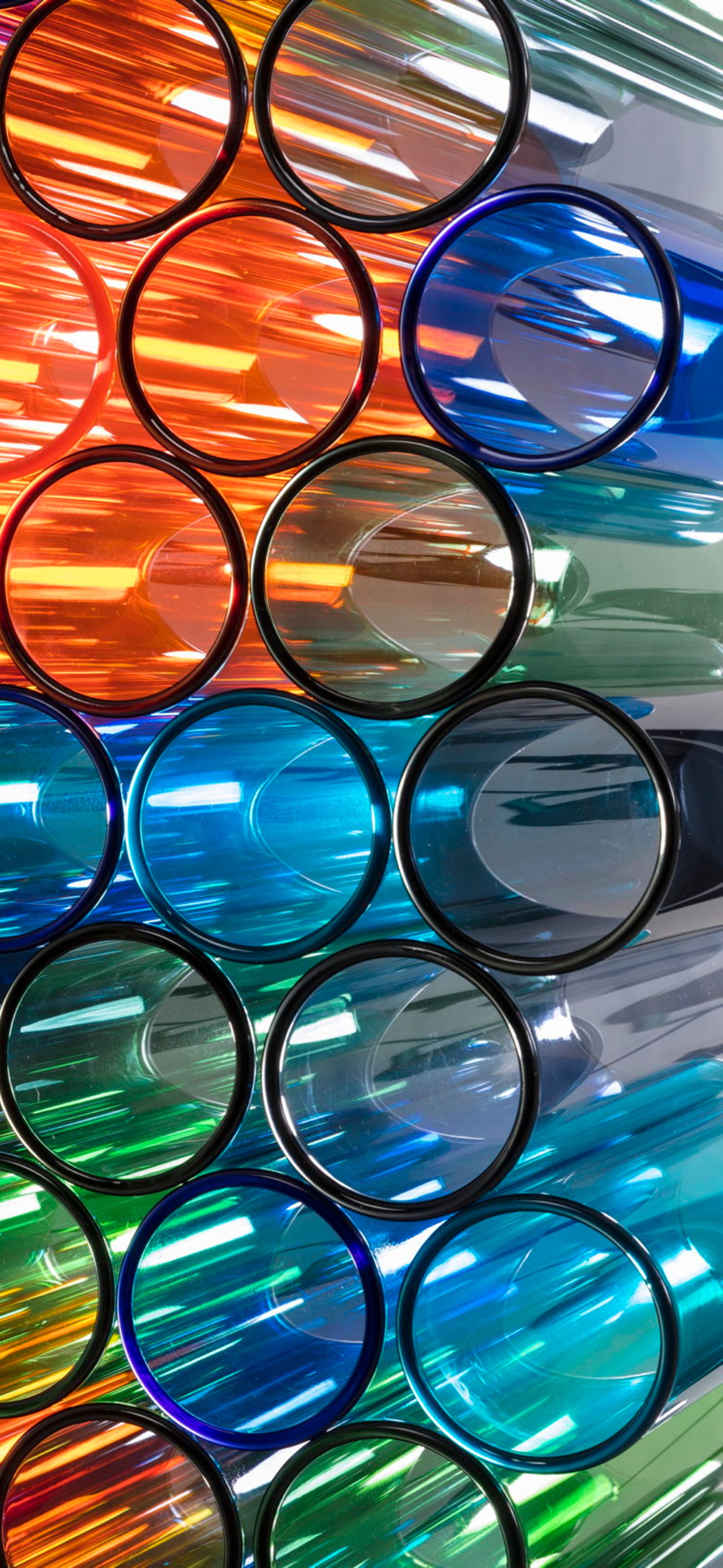 Multicoloured Cylindrical Class pipes stacked atop eachother
