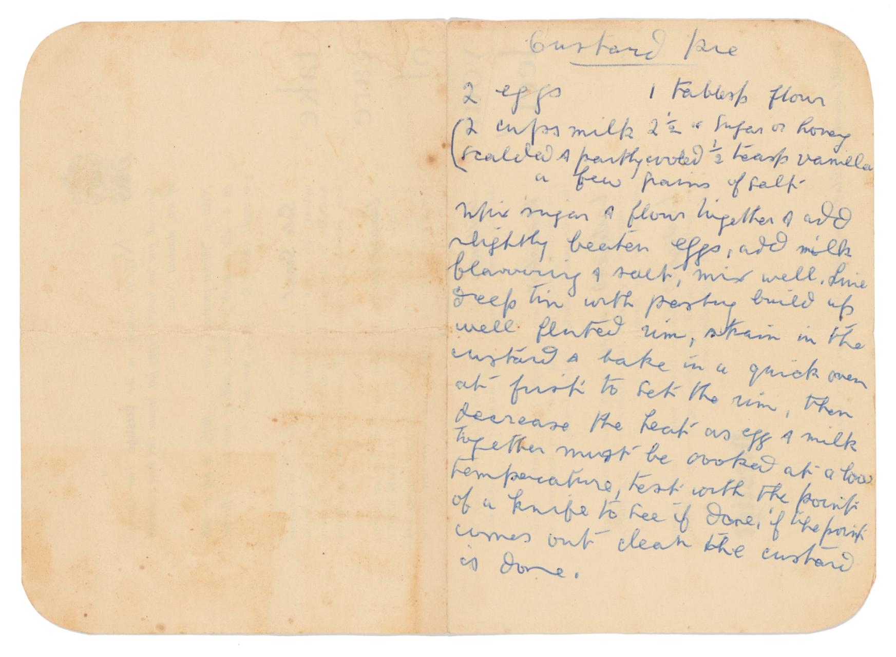 Custard pie recipe handwritten in blue cursive script on yellowing pages from a notebook rounded at the corners with ingredients including eggs, milk and flour.