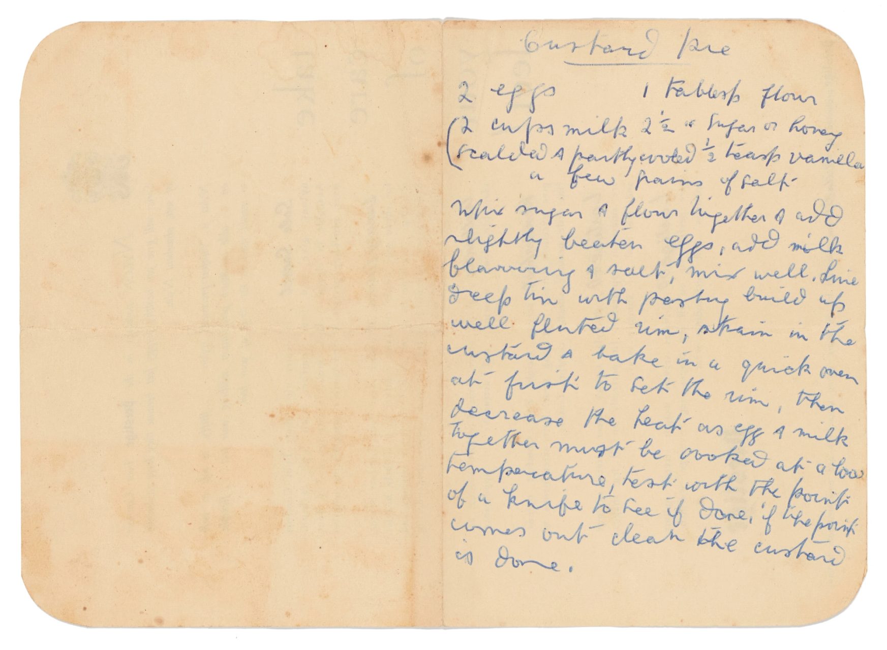 Custard pie recipe handwritten in blue cursive script on yellowing pages from a notebook rounded at the corners with ingredients including eggs, milk and flour.