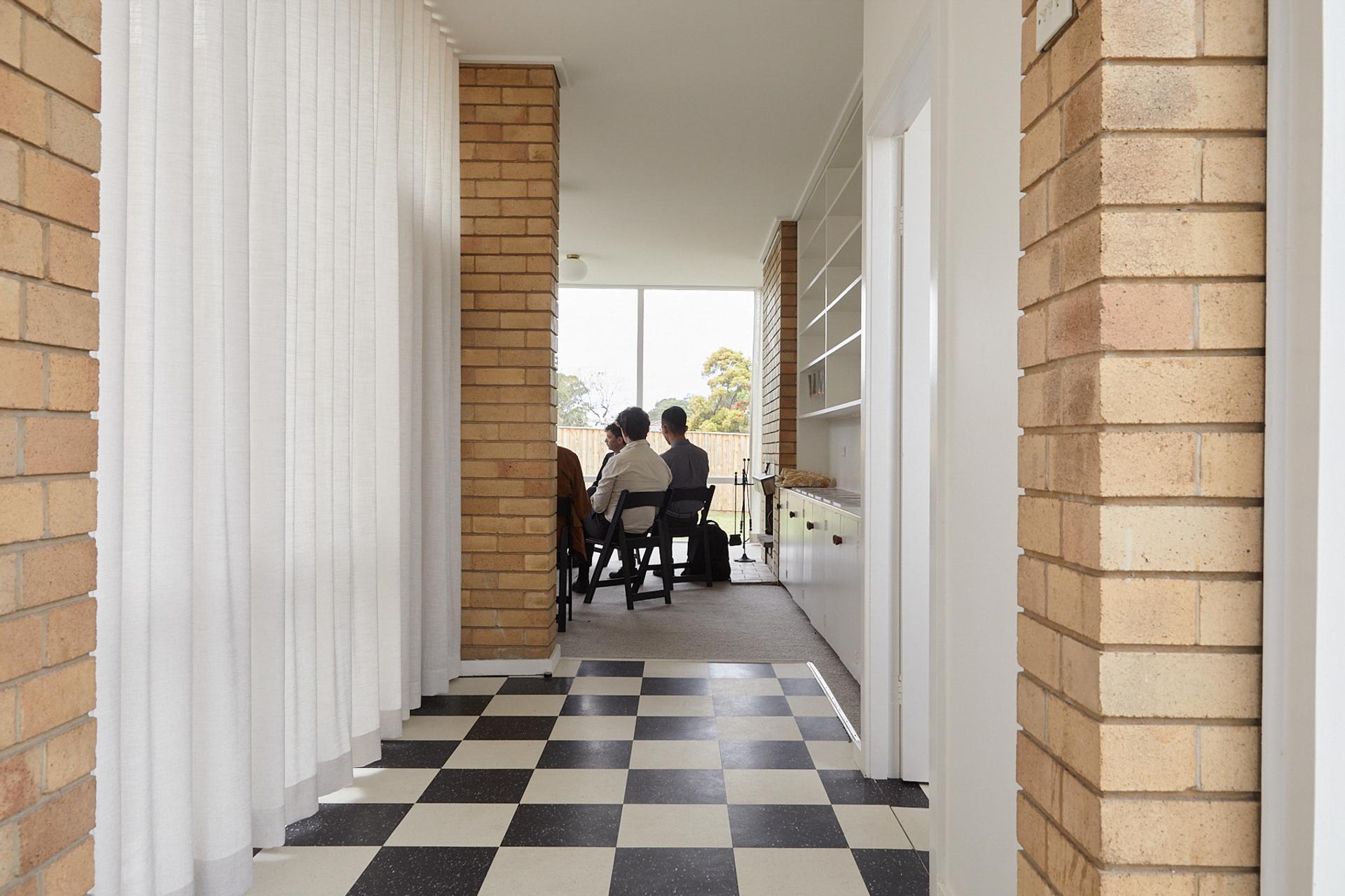 Inside a house with people sitting