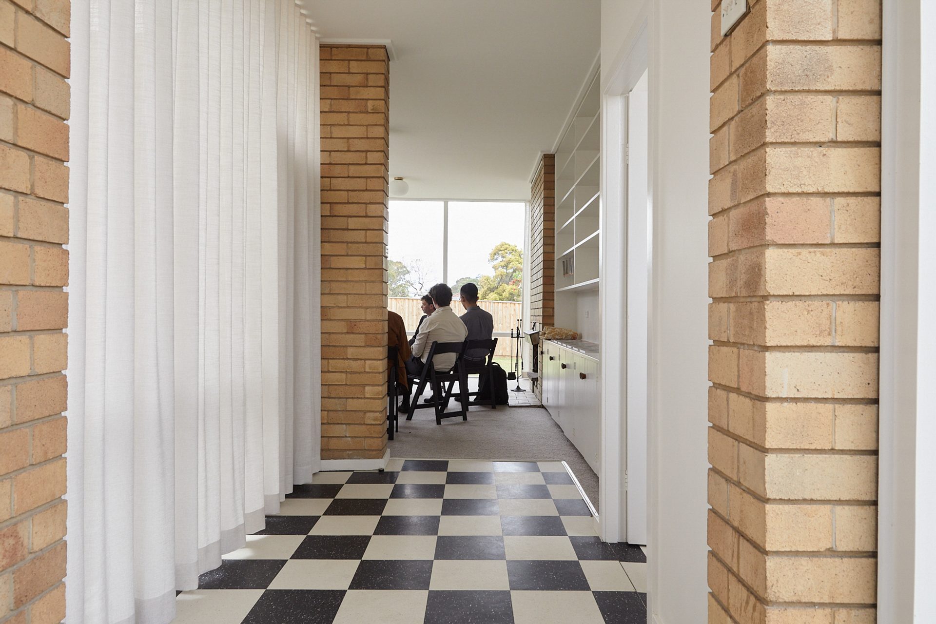 Inside a house with people sitting