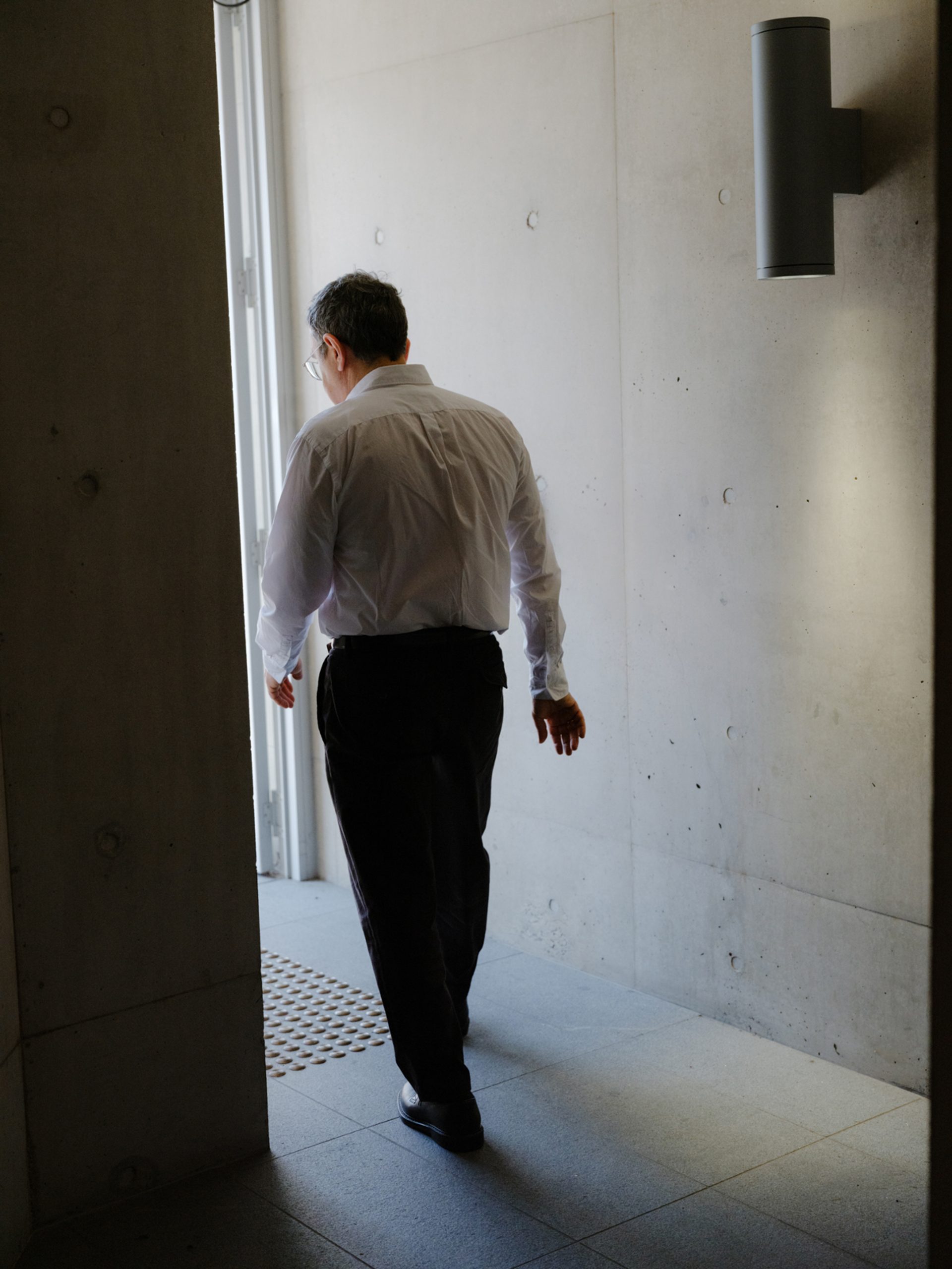 Figure walking away through a doorway