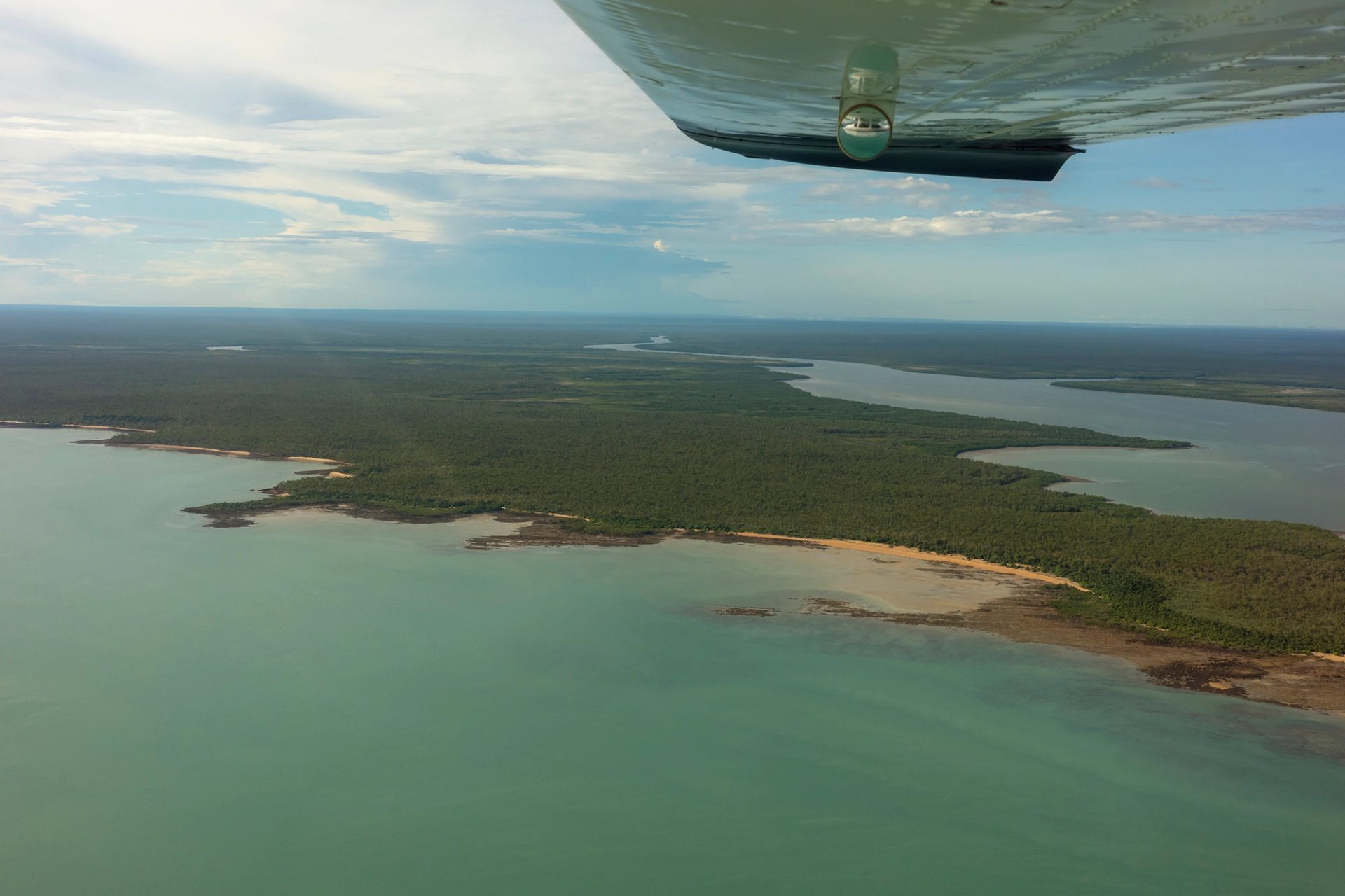 An aerial view of Laŋarra taken from the window of a small passenger plane.