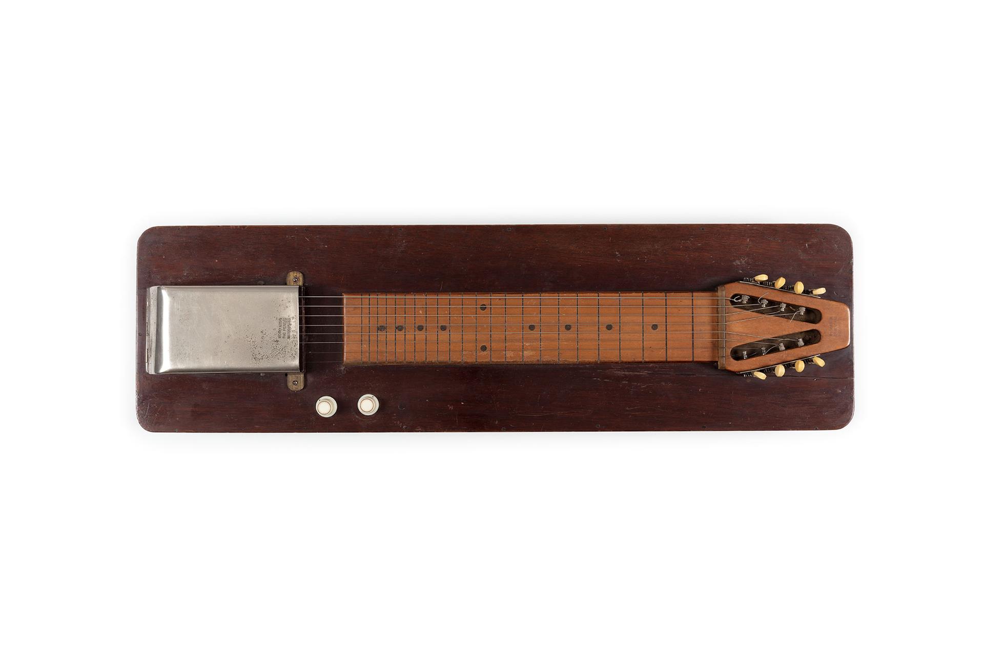 A Wooden board with the guitar neck with eight strings laid flat against it.
