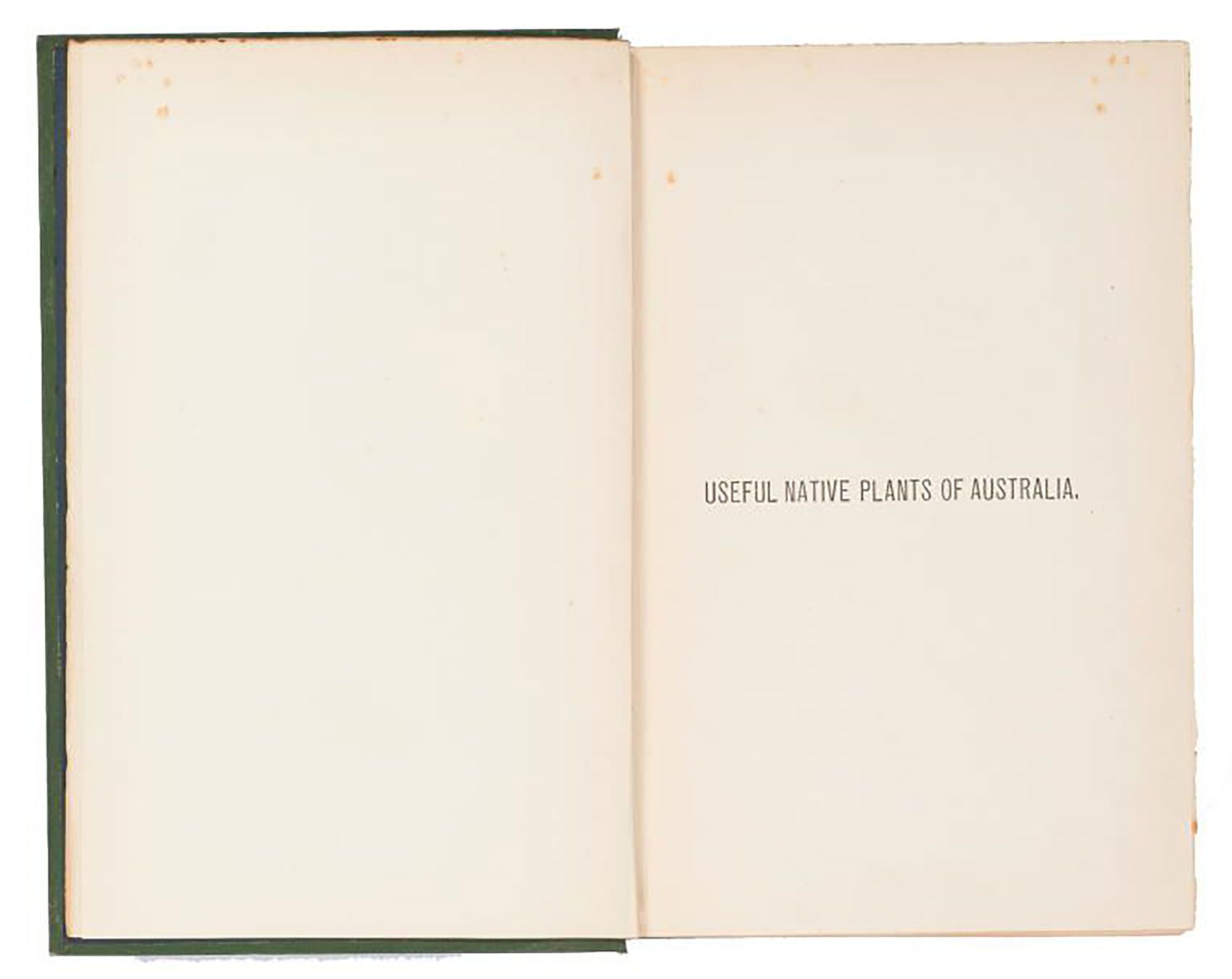A book bound with a green cover. On the spine of the book ‘The Useful Native Plants of Australia’ is embossed in gold. The text on the title page of the book reads ‘Useful native plants of Australia.’