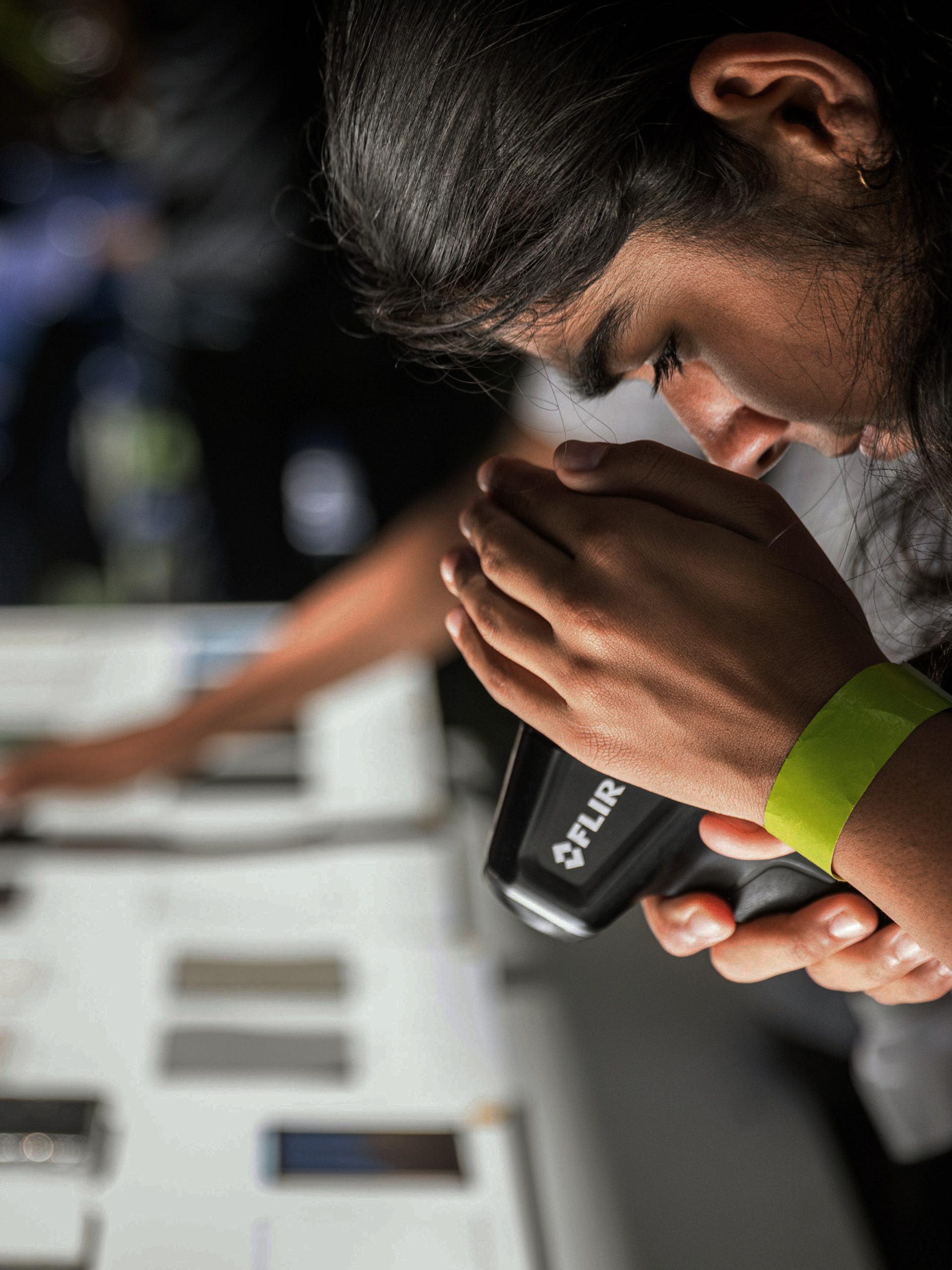 Student looking into a tool.