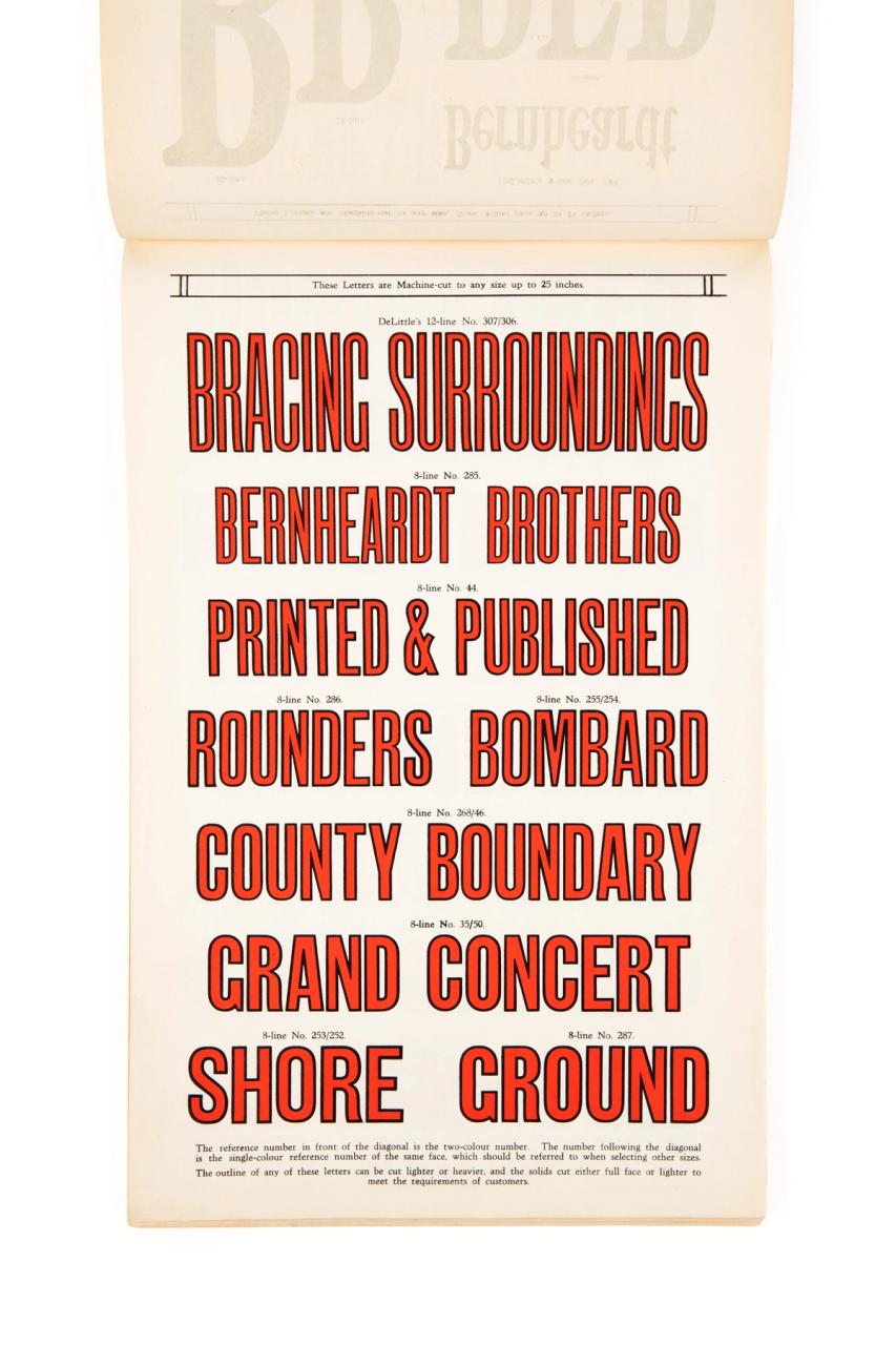 Page from a book showing large red lettering with black outlines.