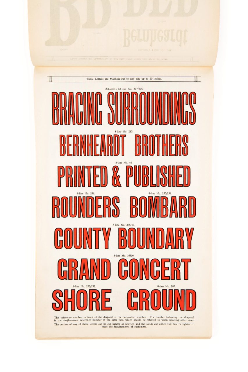 Page from a book showing large red lettering with black outlines.