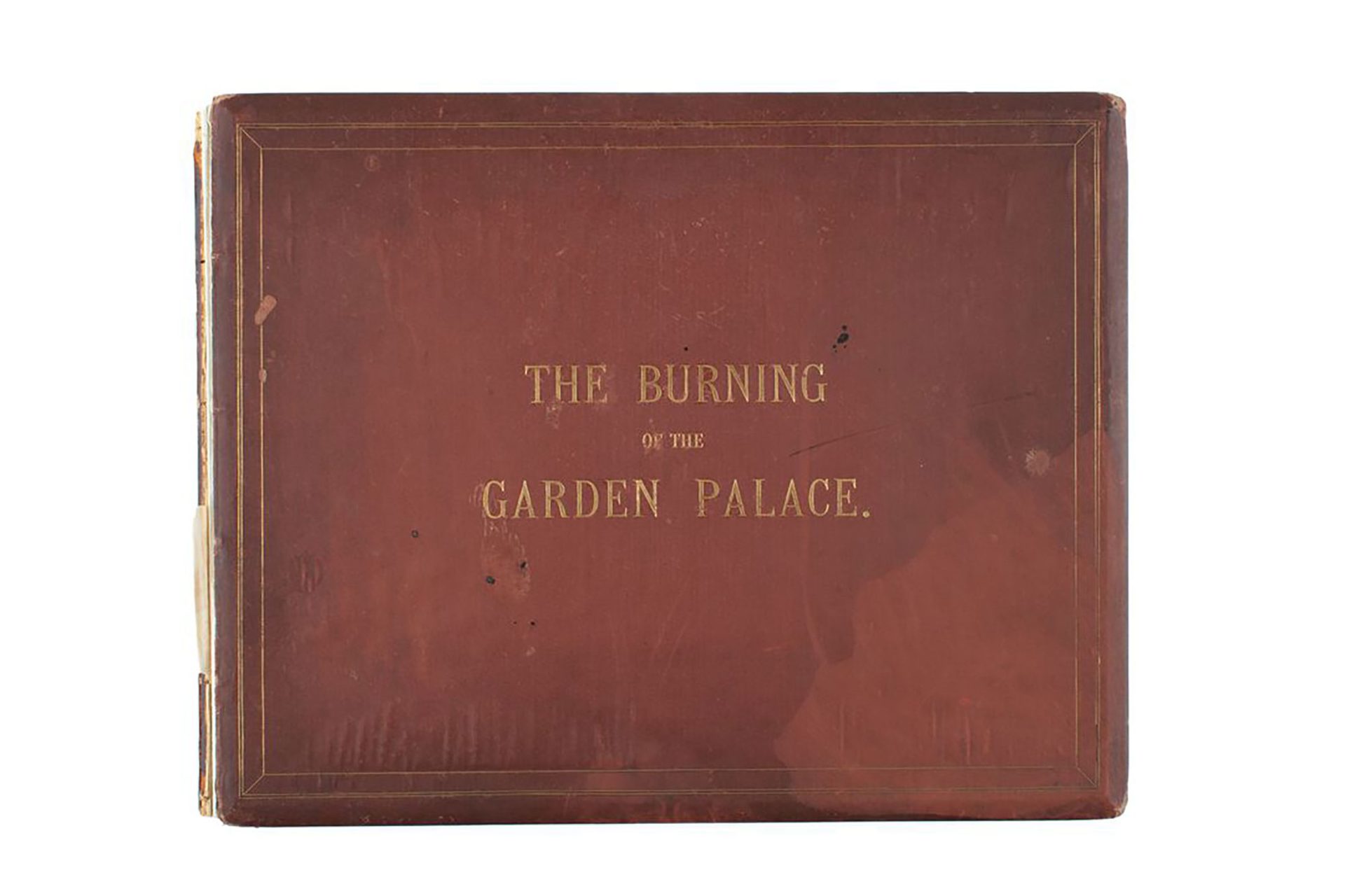 Published album of sepia photos entitled 'The Burning of the Garden Palace', showing the Garden Palace Building, Sydney, before and after the fire. Contains four page introduction which is a reproduction of an article from the 'Sydney Morning Herald', 23 September 1882. Bound in maroon buckram with gold lettering and border on cover. Cover, binding and pages are all separated.