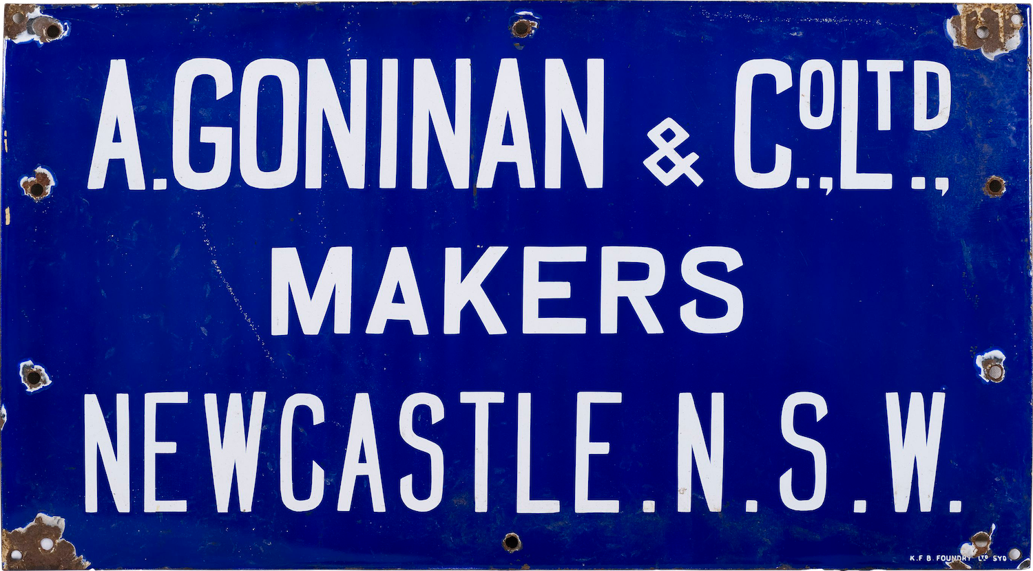 Blue metal sign with white lettering. There is rust in the corners.