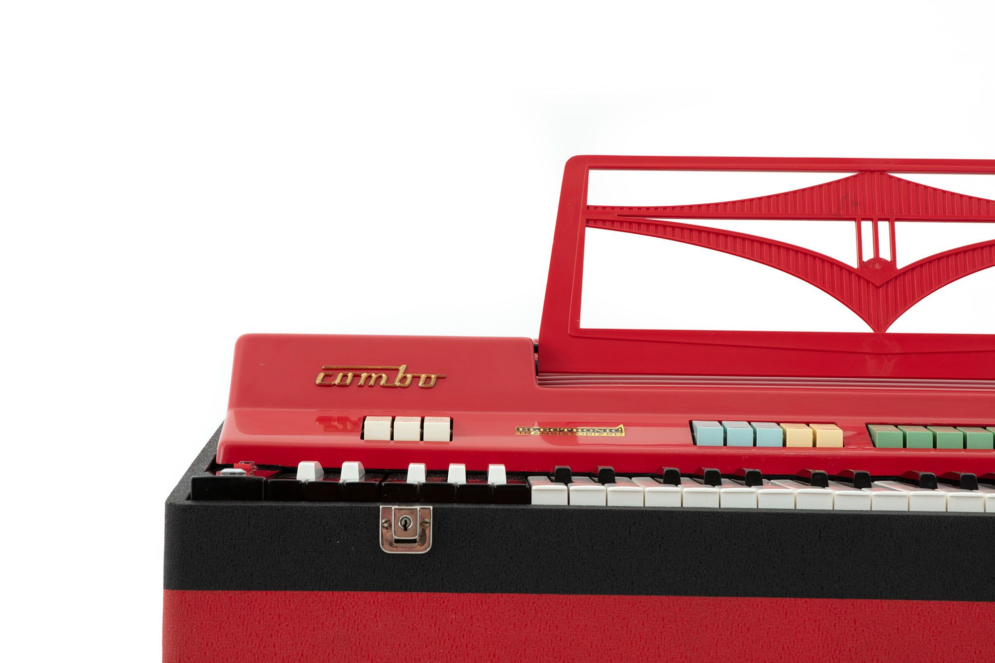 The left end of a bright red keyboard with the word ‘combo’ written above the keyboard and a number of colourful buttons