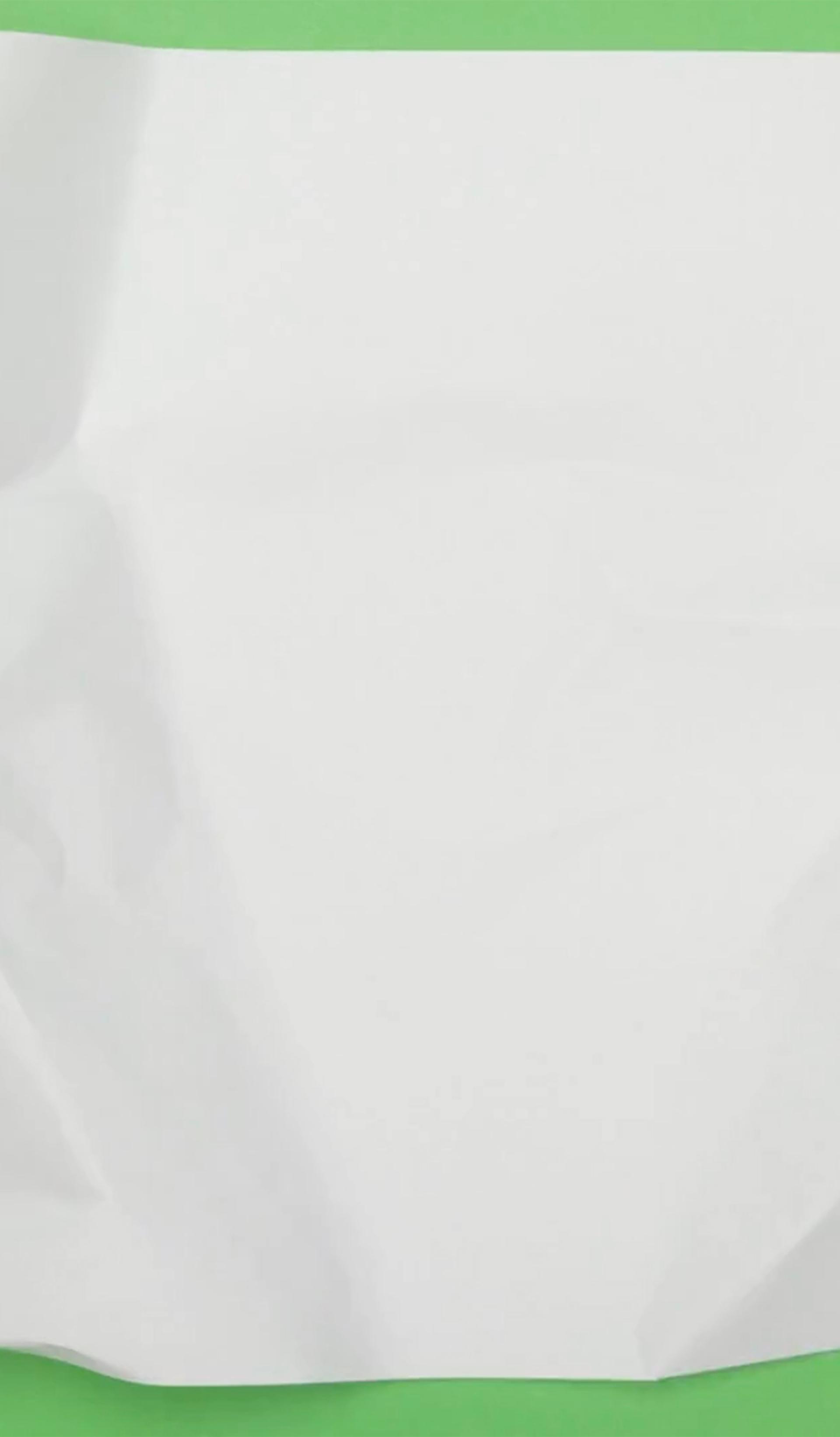 Animated footage of a sheet of paper being scrunched down to a ball, against a bright green background.