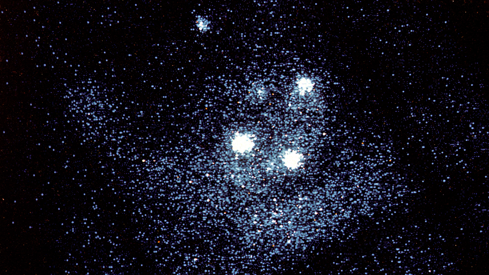 An x-ray image of the Eta Carinae Nebula, showing 3 large and bright clusters of stars.
