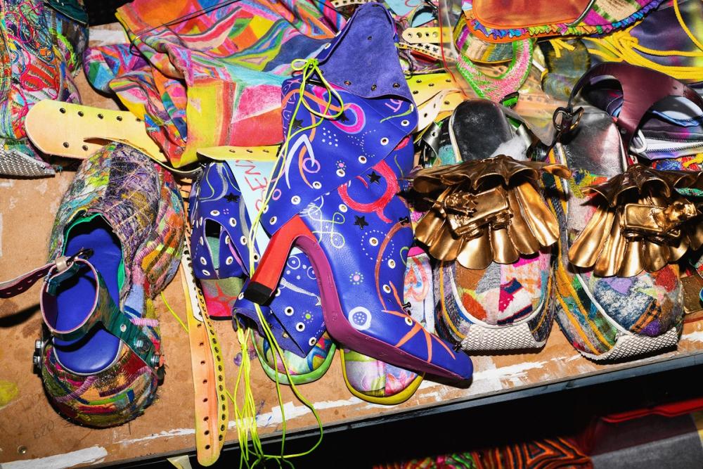 a pile of multicoloured patterned shoes on a table