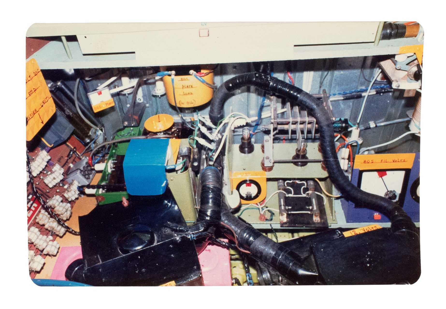 Green and yellow metal 'garden' shed containing elaborate electronic systems built into the interior. Inside the shed is a compartment which contains a seat where the user can sit and be suffused with radio waves produced by the electronic system.