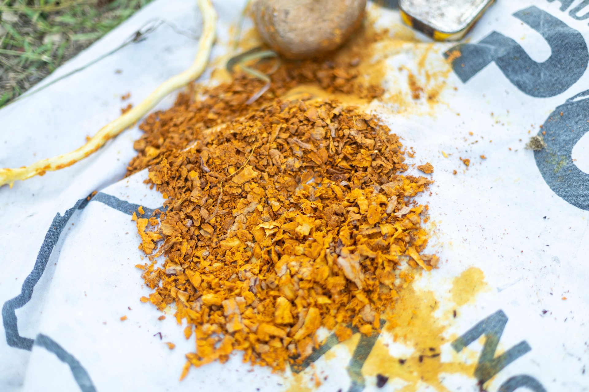 A close up of natural yellow dye materials on an old Australia Post bag.