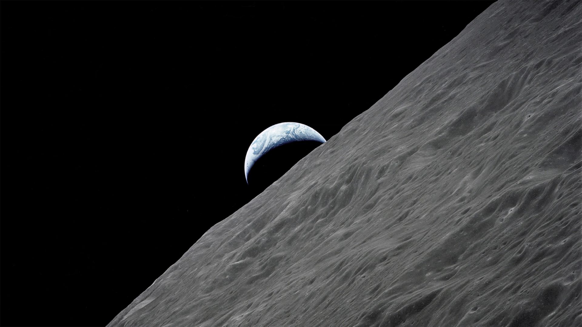 Image of Earth rising above the Moon's horizon.