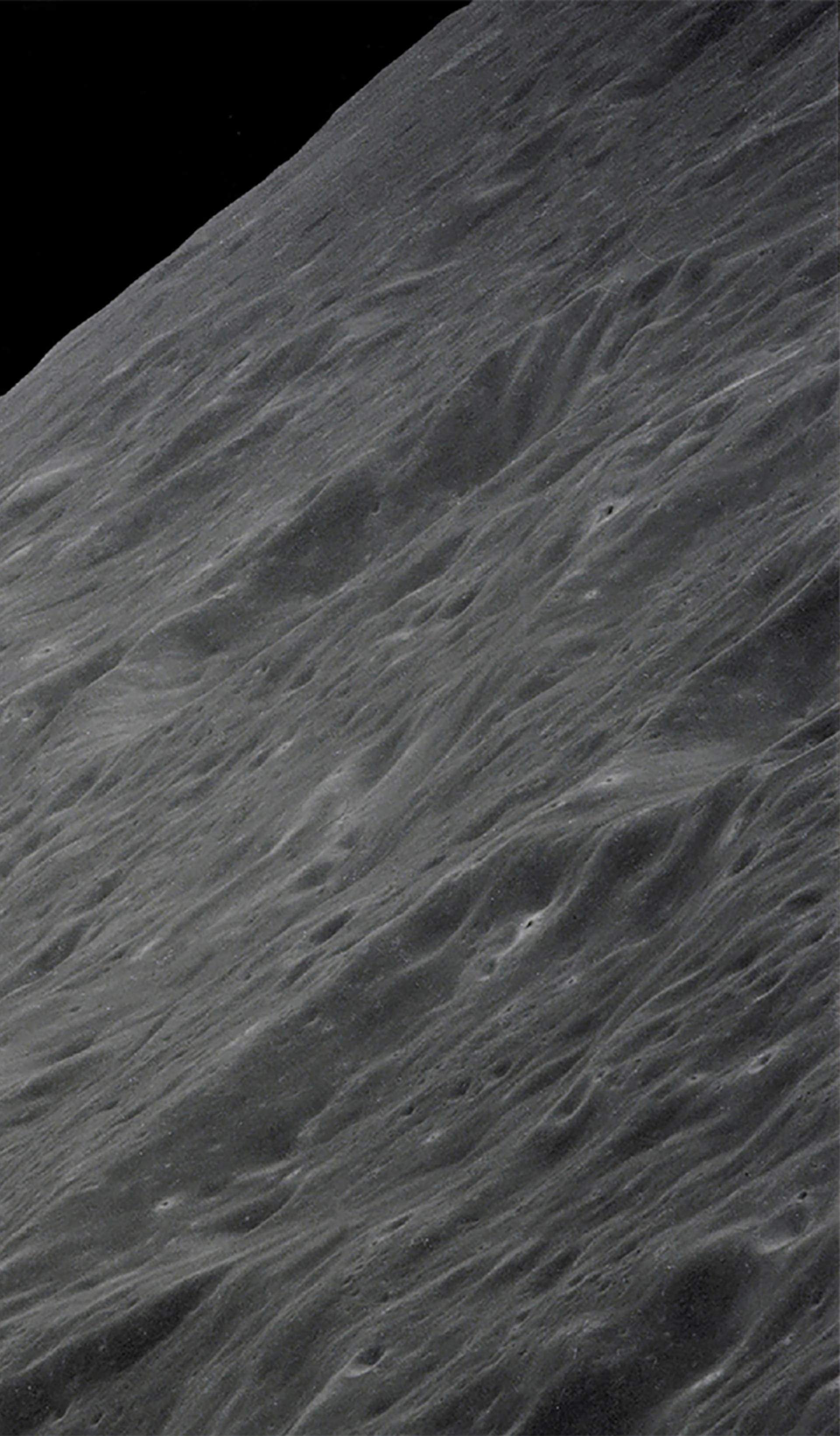 Image of Earth rising above the Moon's horizon.