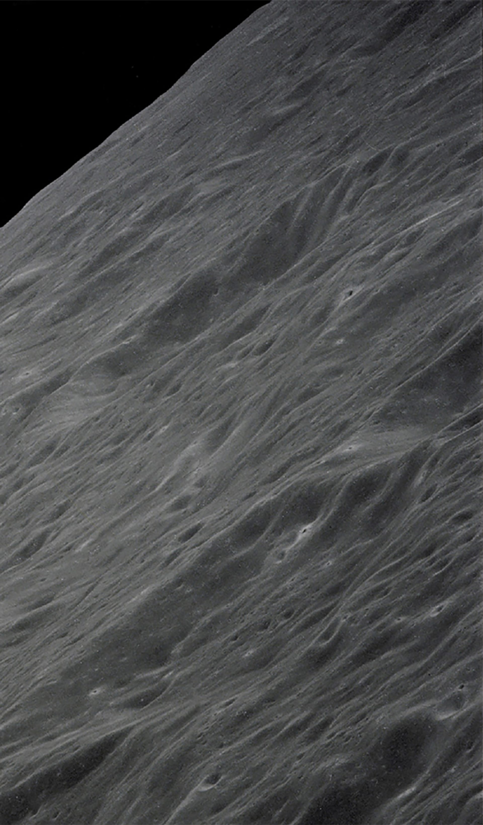 Image of Earth rising above the Moon's horizon.