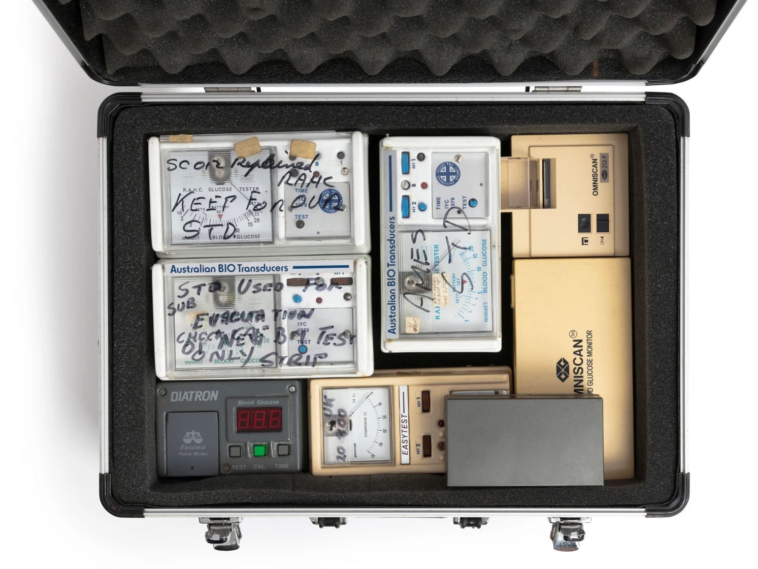 Prototype portable blood glucose meters in a case.