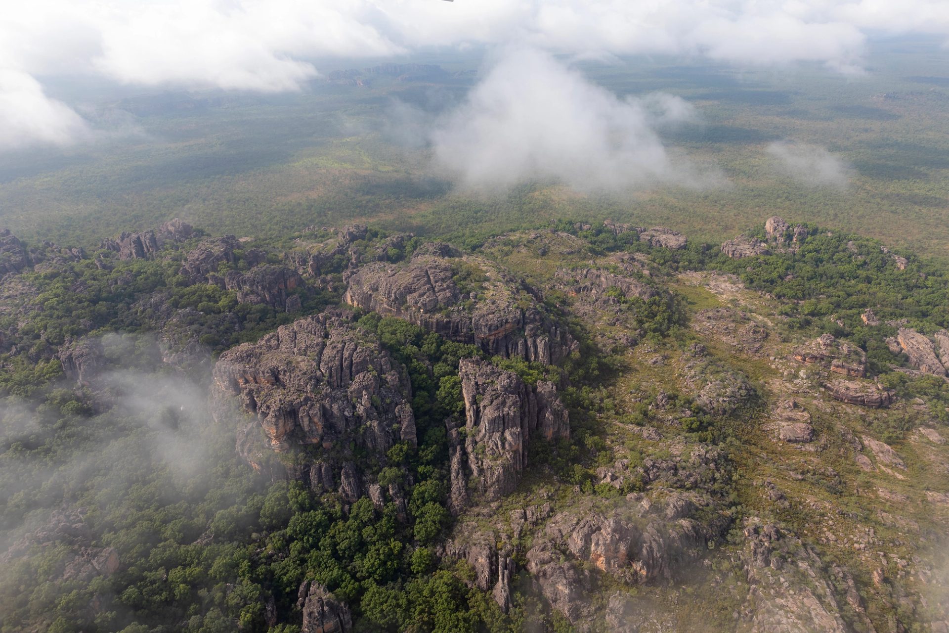 An aerial view of a green and rocky landscape