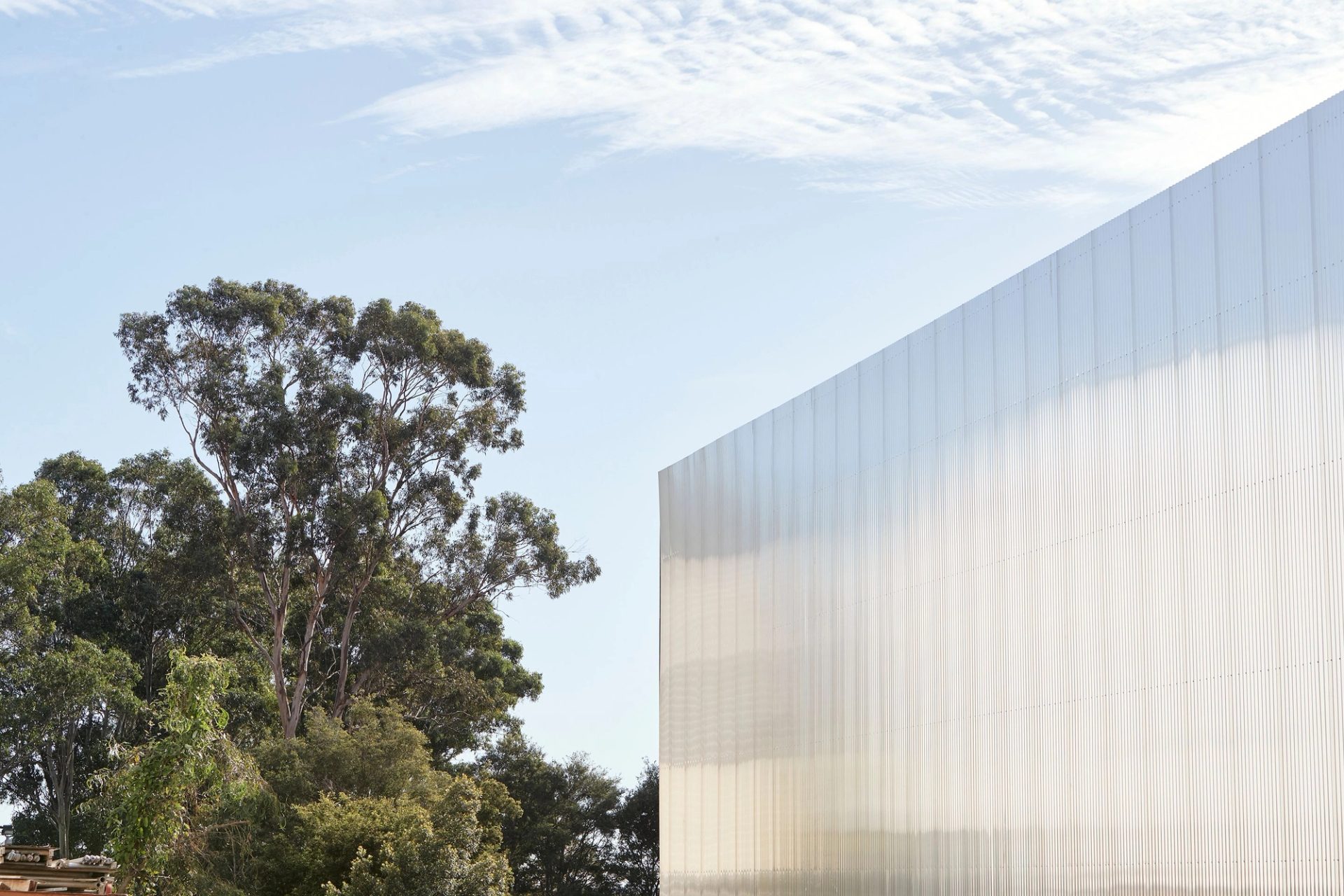 abstract construction image with large wall and trees
