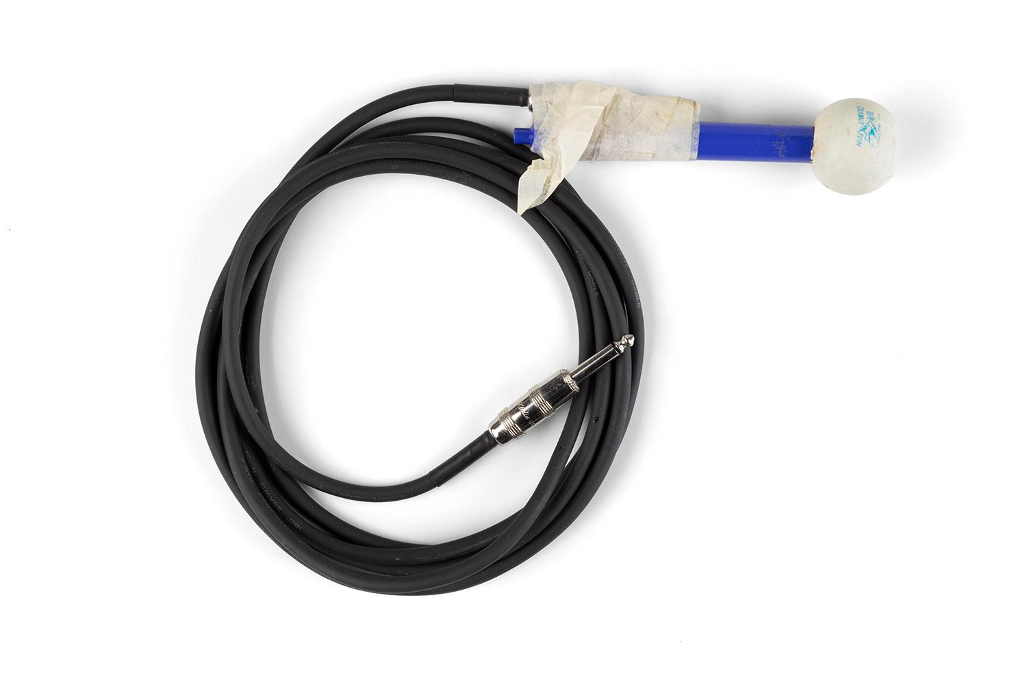 A microphone made of a long black coiled chord sticky taped to a blue handle with a ping pong ball for the mouth piece.