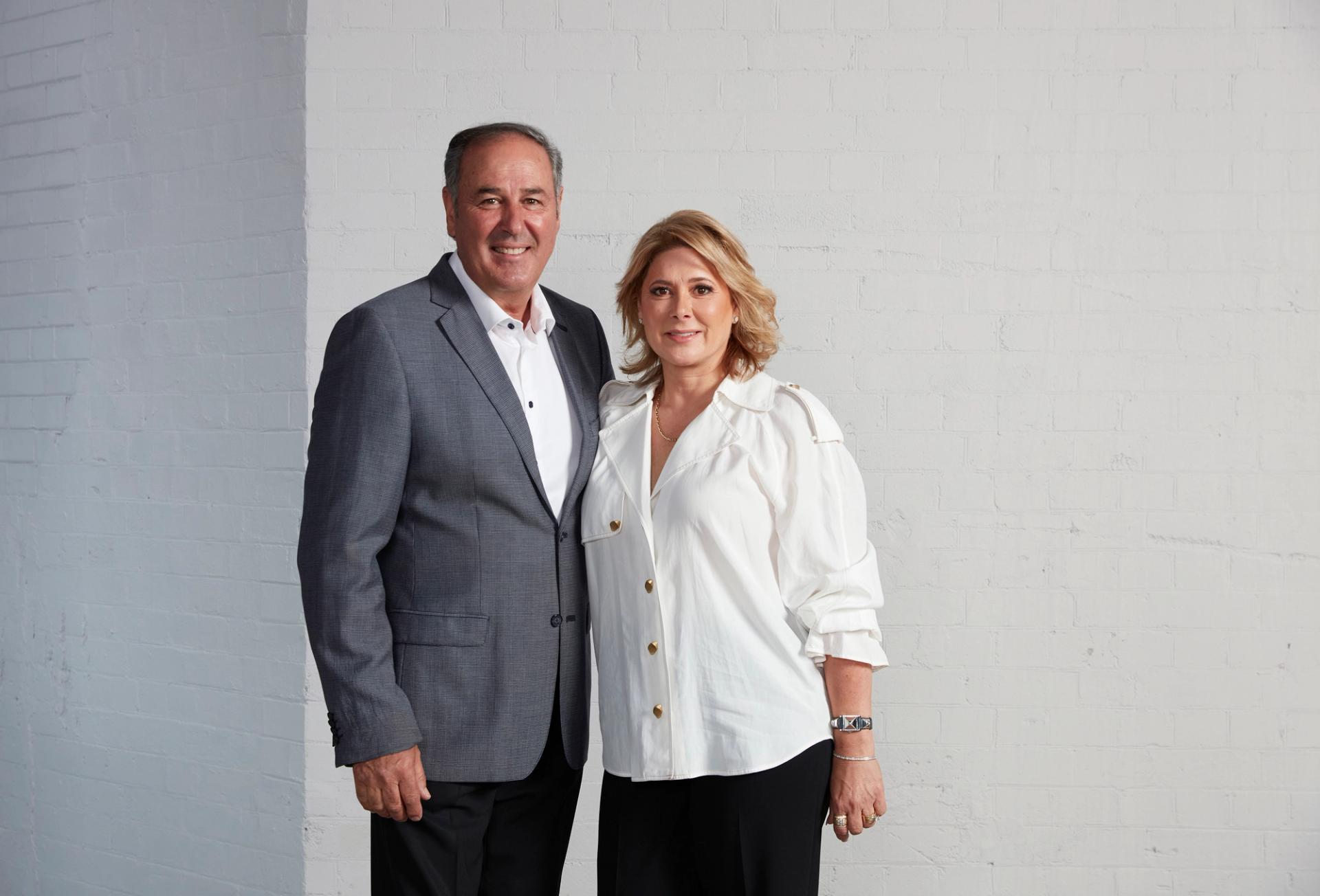 two humans stand side by side for the camera