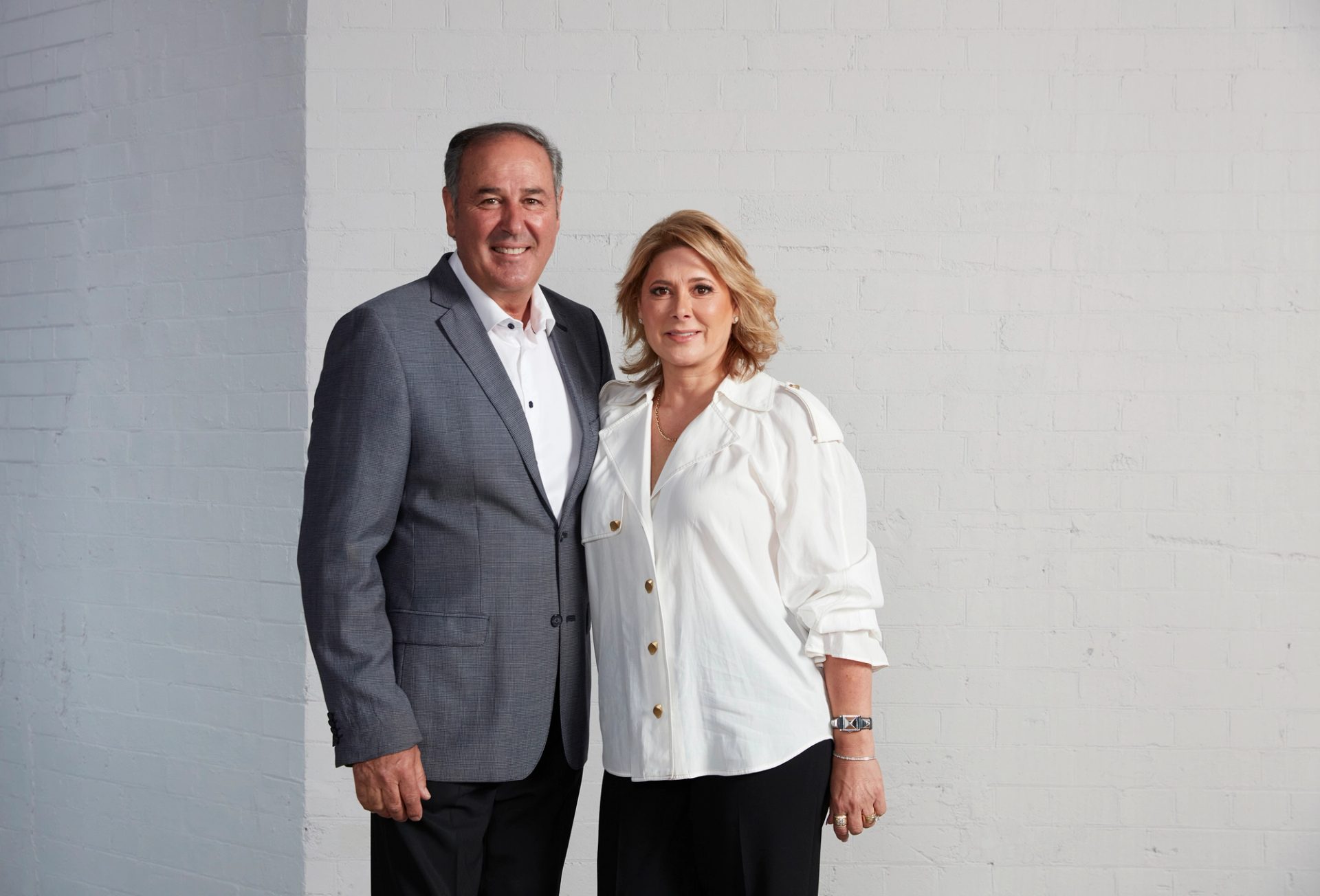 two humans stand side by side for the camera
