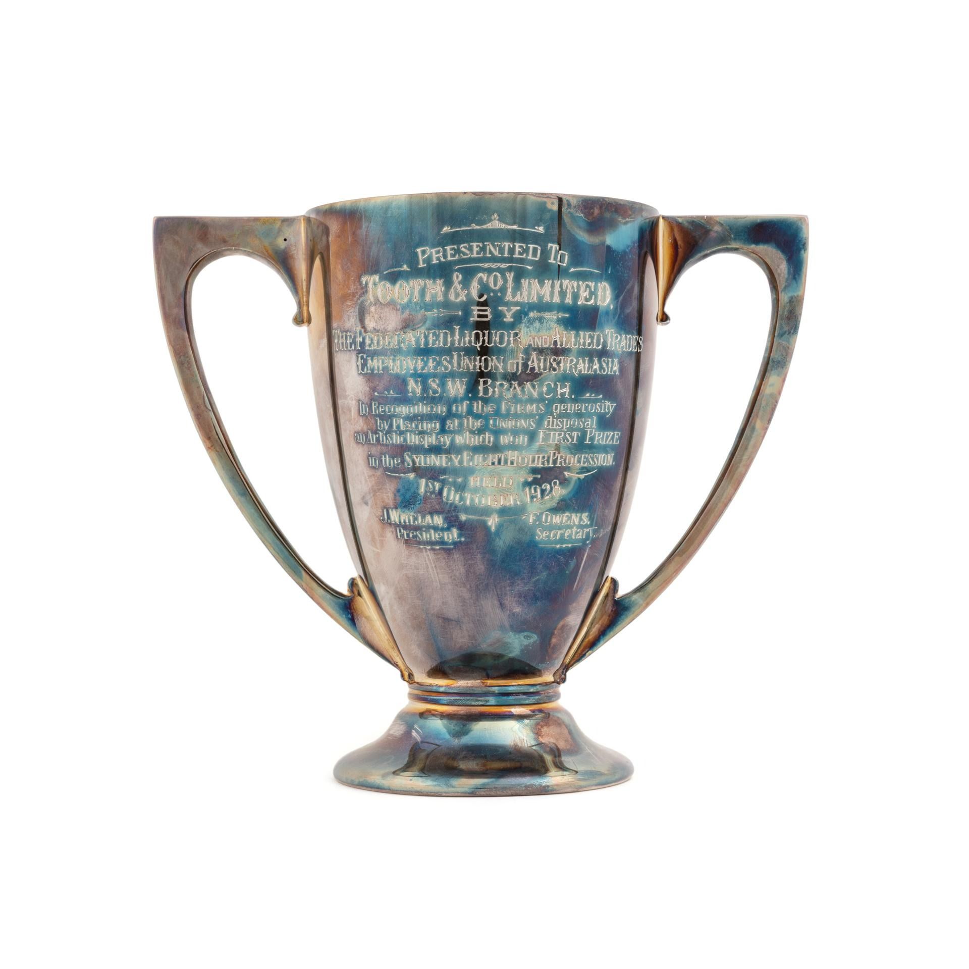 Two handled trophy with text: 'Presented to Tooth & Co Limited by the Federated Liquor & Applied Trades Union'