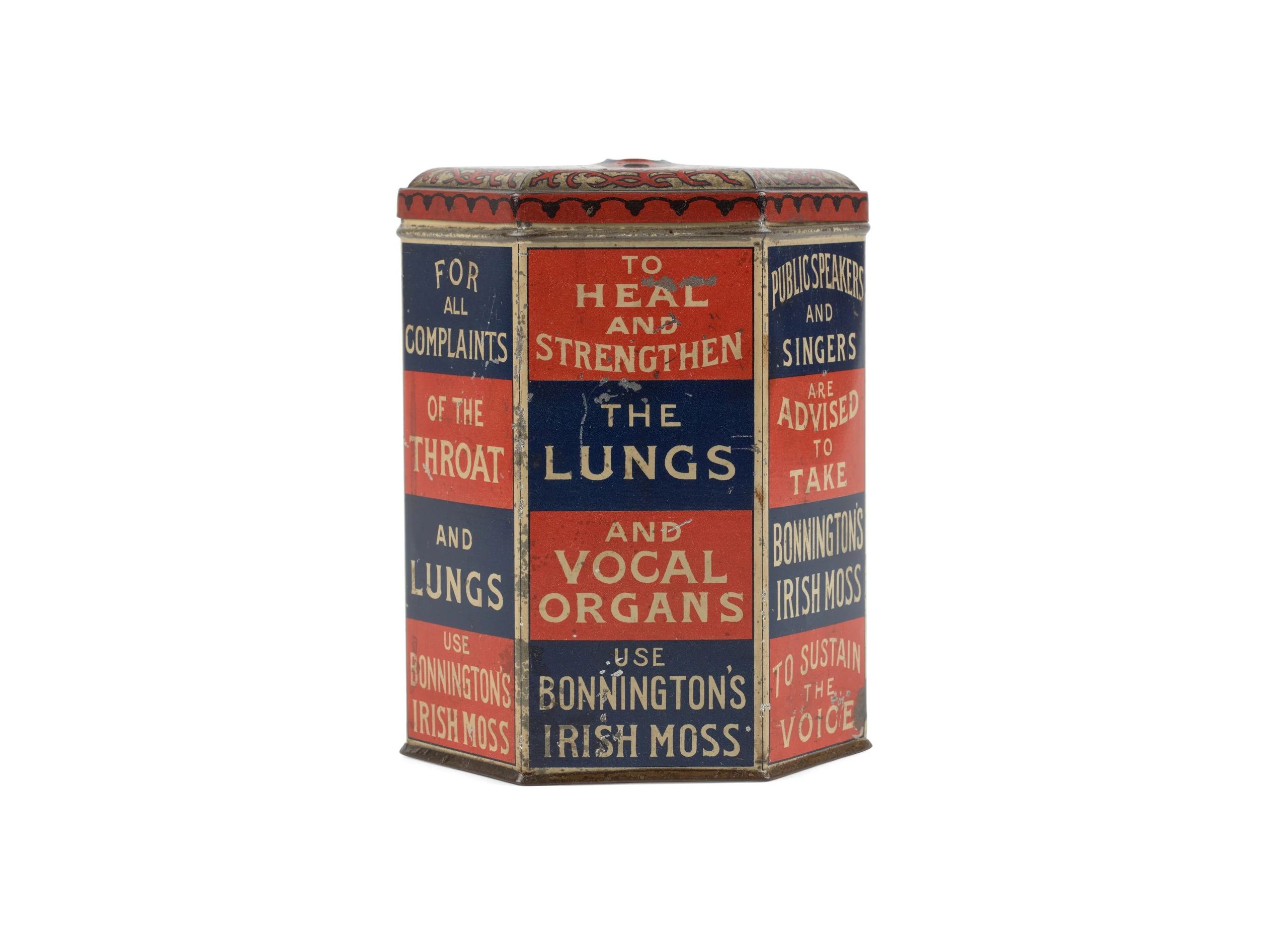 A red and navy-blue hexagonal tin container with a lid. Cream text on the sides reads 'Bonnington's Irish Moss'.