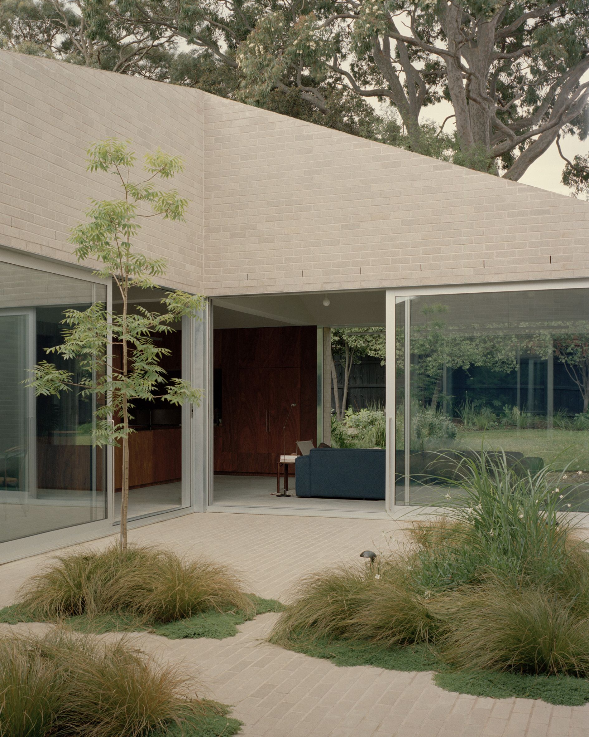A small constructed garden next to the facade of a building.
