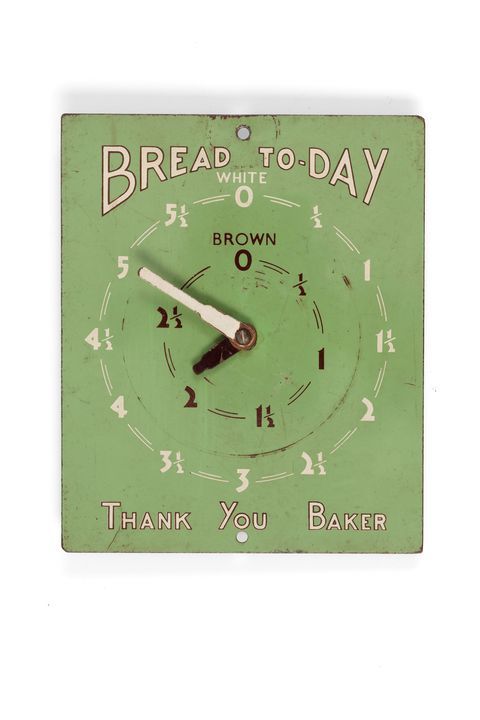 Bread order indicator, 'Bread Today', domestic, board with 2 indicator 'arms' and 2 circular dials showing number of loaves required, white or brown, sheet metal, green enamelled.