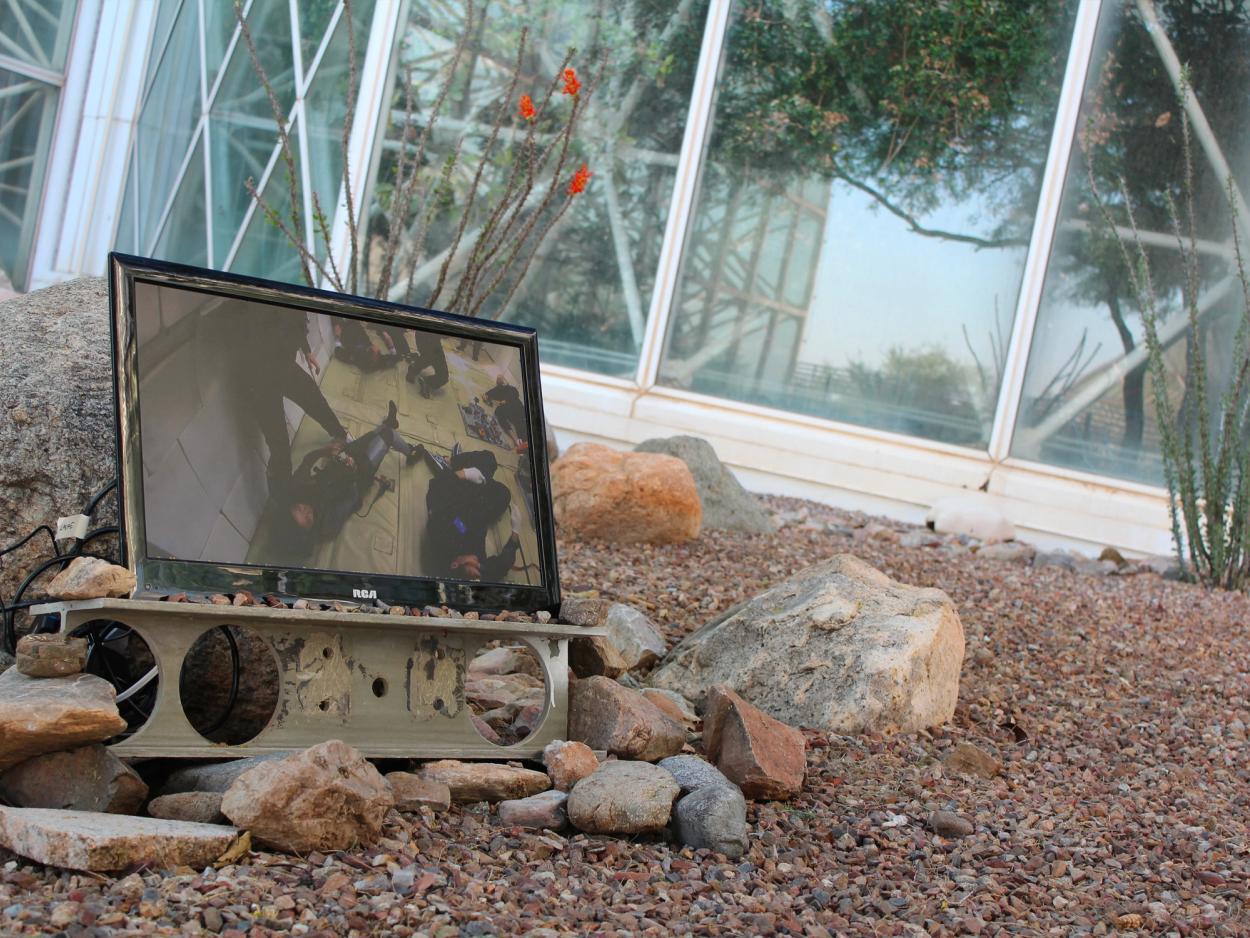 The Orbit Weaver on display in a rocky courtyard.